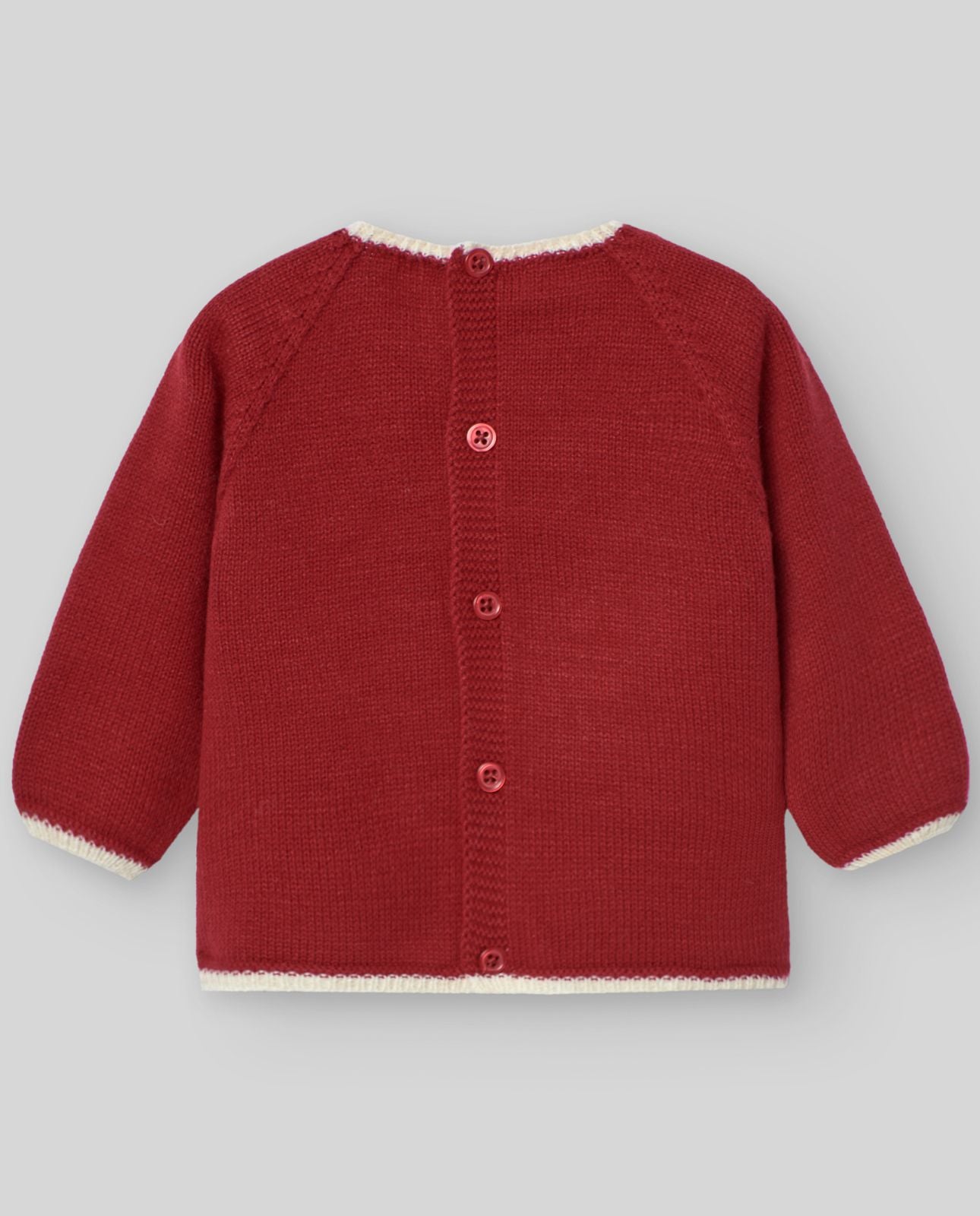 A baby is wearing a red sweater and pants with a snowflake on it.;A red sweater with a white snowflake on it;The back of a red sweater with white trim and buttons.;A pair of red knitted baby pants with feet
