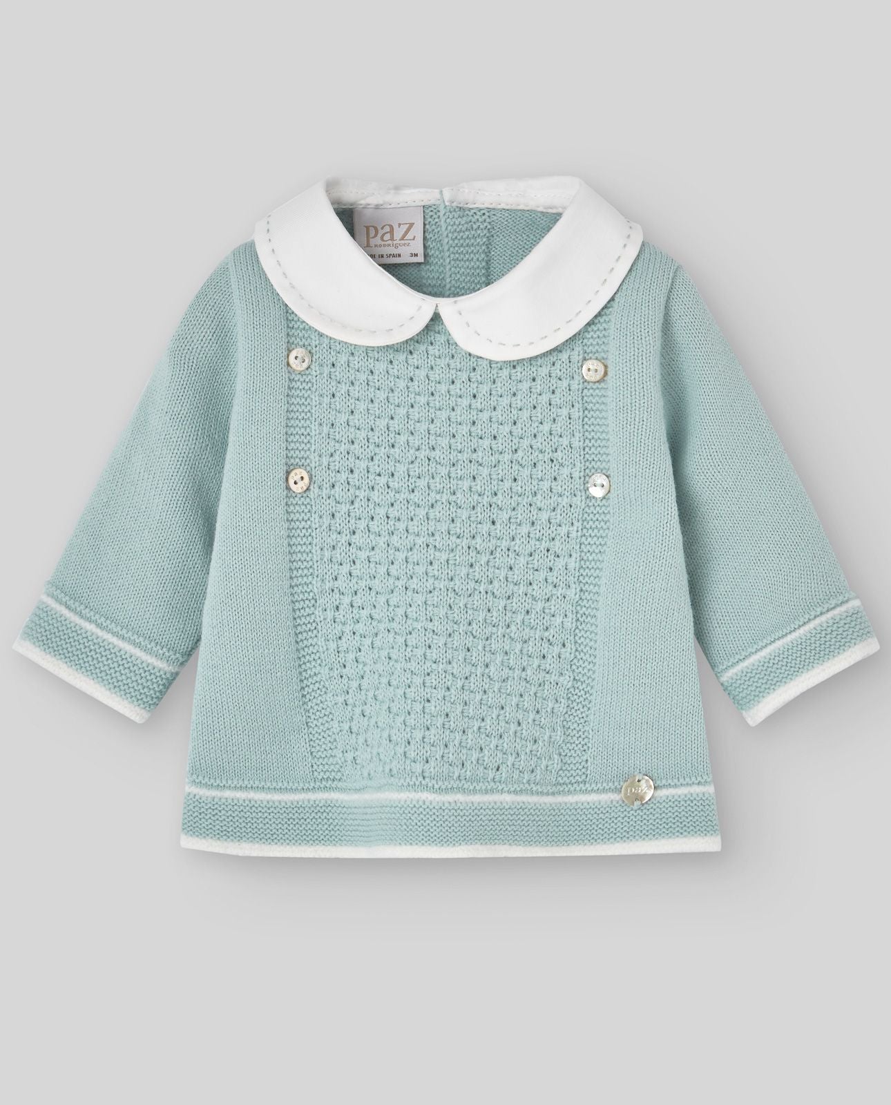 A baby is wearing a green sweater with a white collar.;A baby is wearing a green sweater with a white collar.;A pair of knitted baby pants with feet on a white background.;A pair of baby pants with feet on a white background.;A baby is laying on a bed wearing a hat and a sweater.