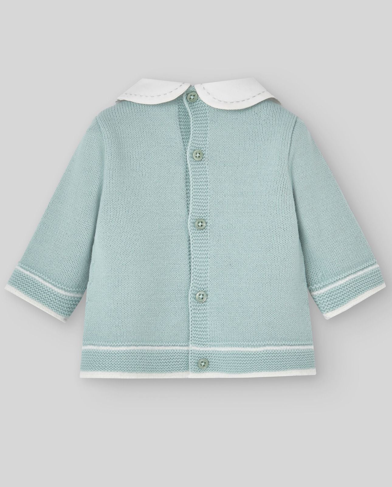 A baby is wearing a green sweater with a white collar.;A baby is wearing a green sweater with a white collar.;A pair of knitted baby pants with feet on a white background.;A pair of baby pants with feet on a white background.;A baby is laying on a bed wearing a hat and a sweater.