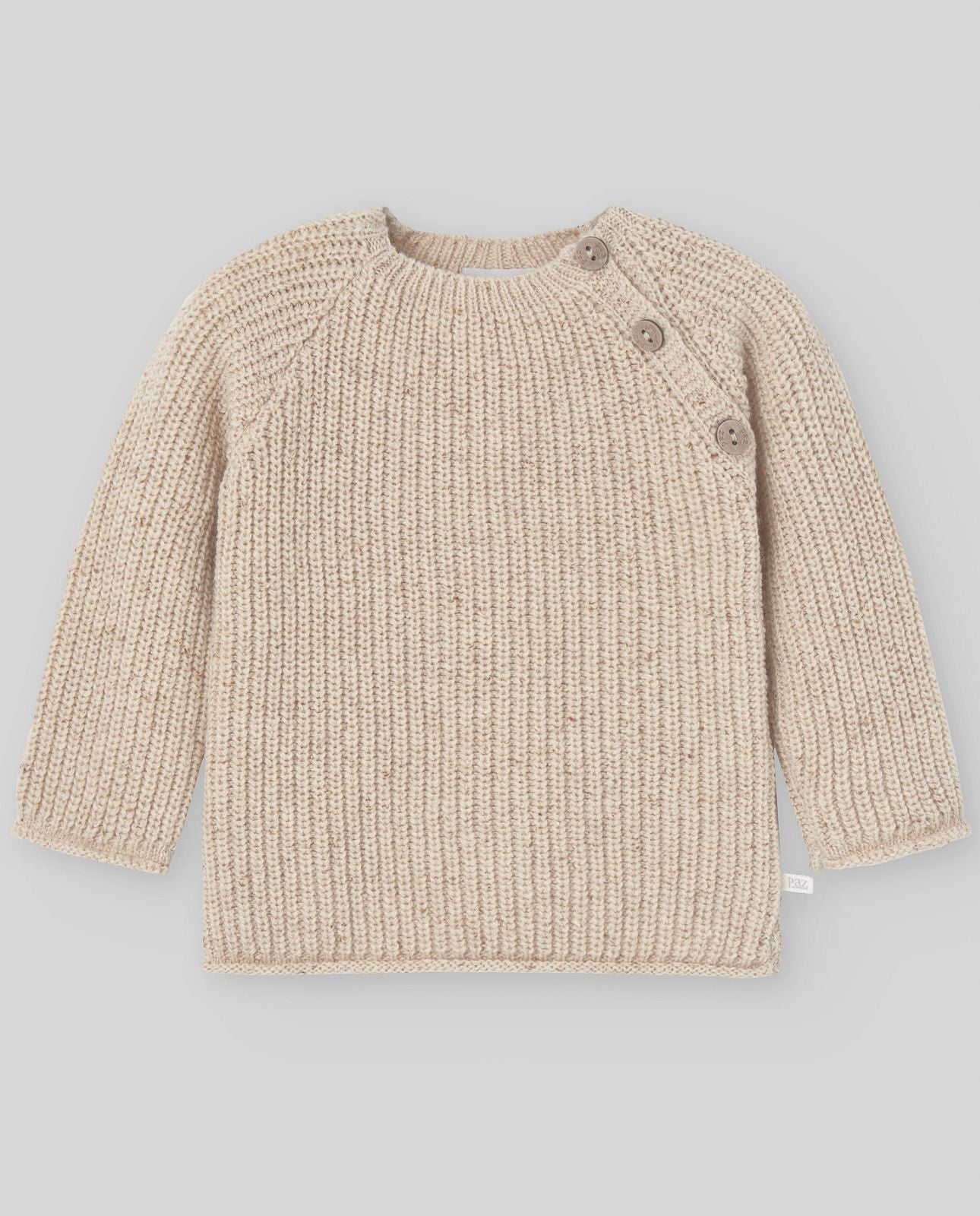 A baby is wearing a beige sweater with buttons on the sleeves.;A close up of a beige sweater with long sleeves on a white background.;A pair of beige pants with a pattern on them on a white background.;A pair of beige pants with a pattern on them