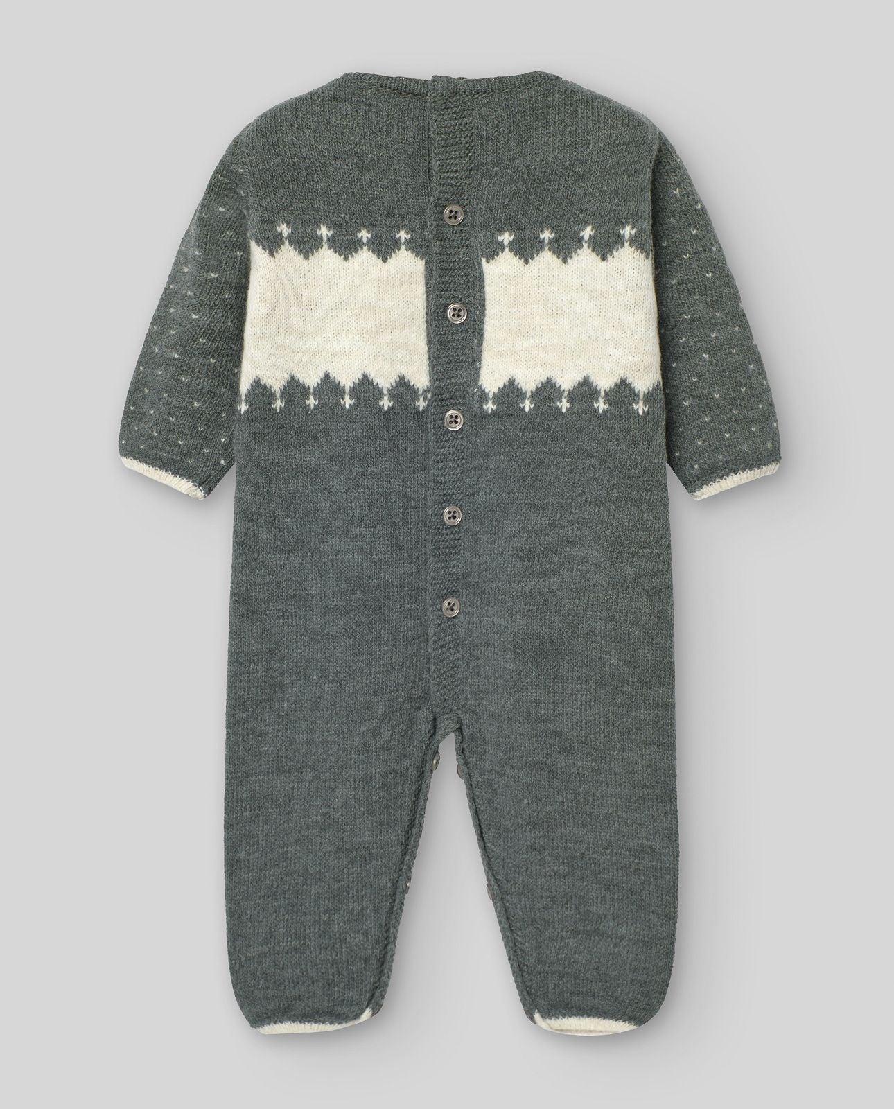 A baby is wearing a sweater with snowflakes on it.;A baby is wearing a grey and white knitted onesie.