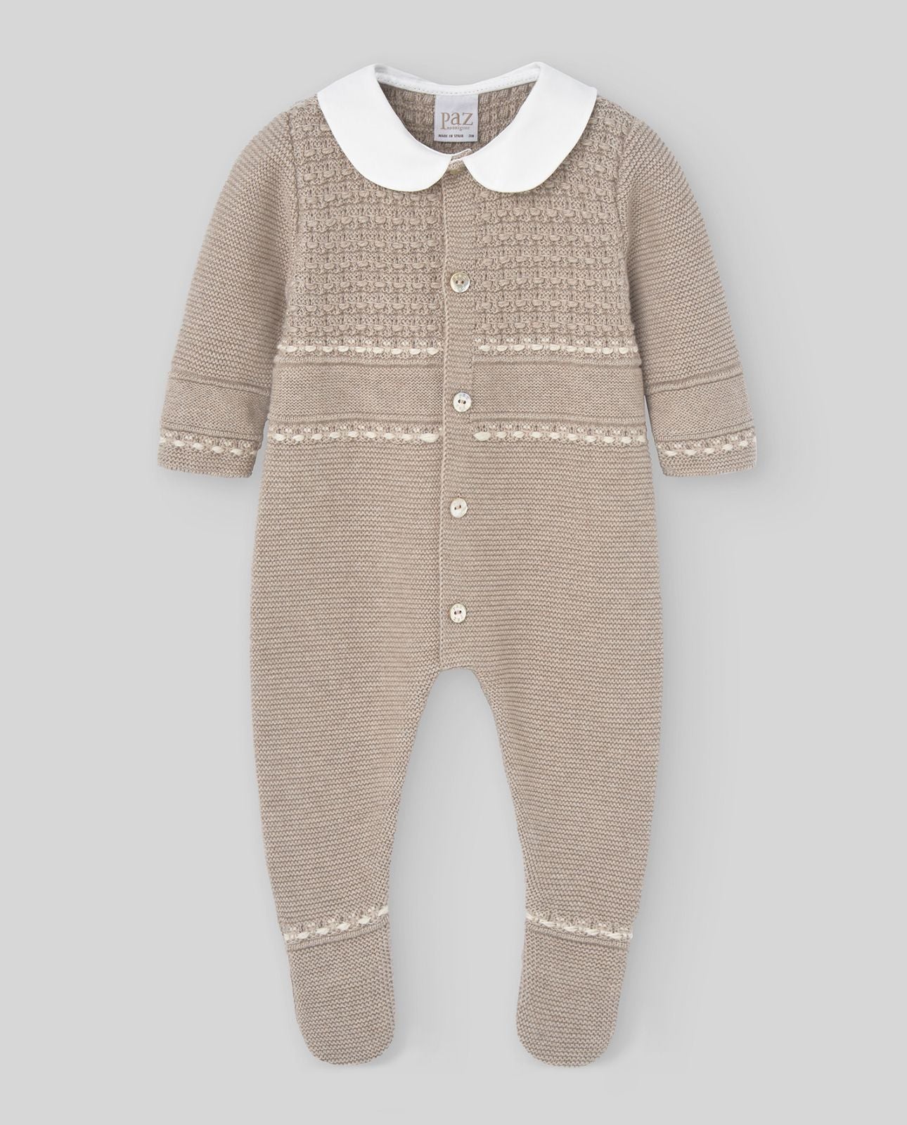 A baby is wearing a knitted onesie with a white collar.;A baby is wearing a knitted outfit with a white collar.