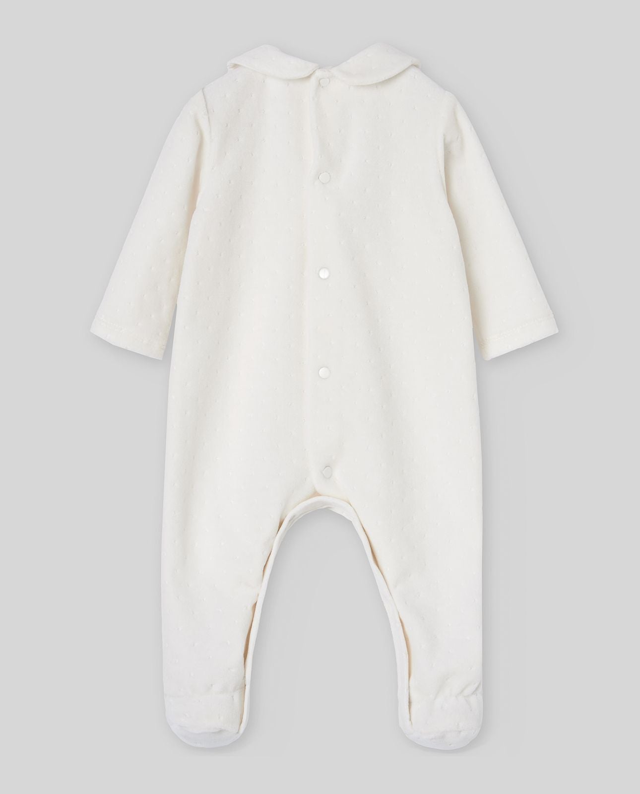 A baby is wearing a white onesie with a collar and buttons.;The back of a white baby onesie with a collar and buttons.