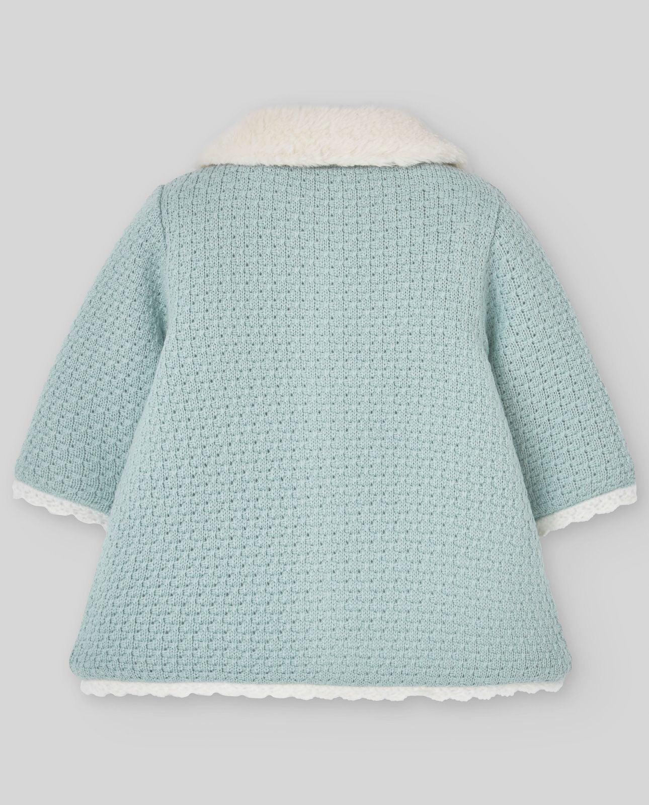 A baby girl is wearing a blue coat with a white fur collar.;A baby girl is wearing a light blue coat with a white collar.;A baby 's clothes are laid out on a white surface