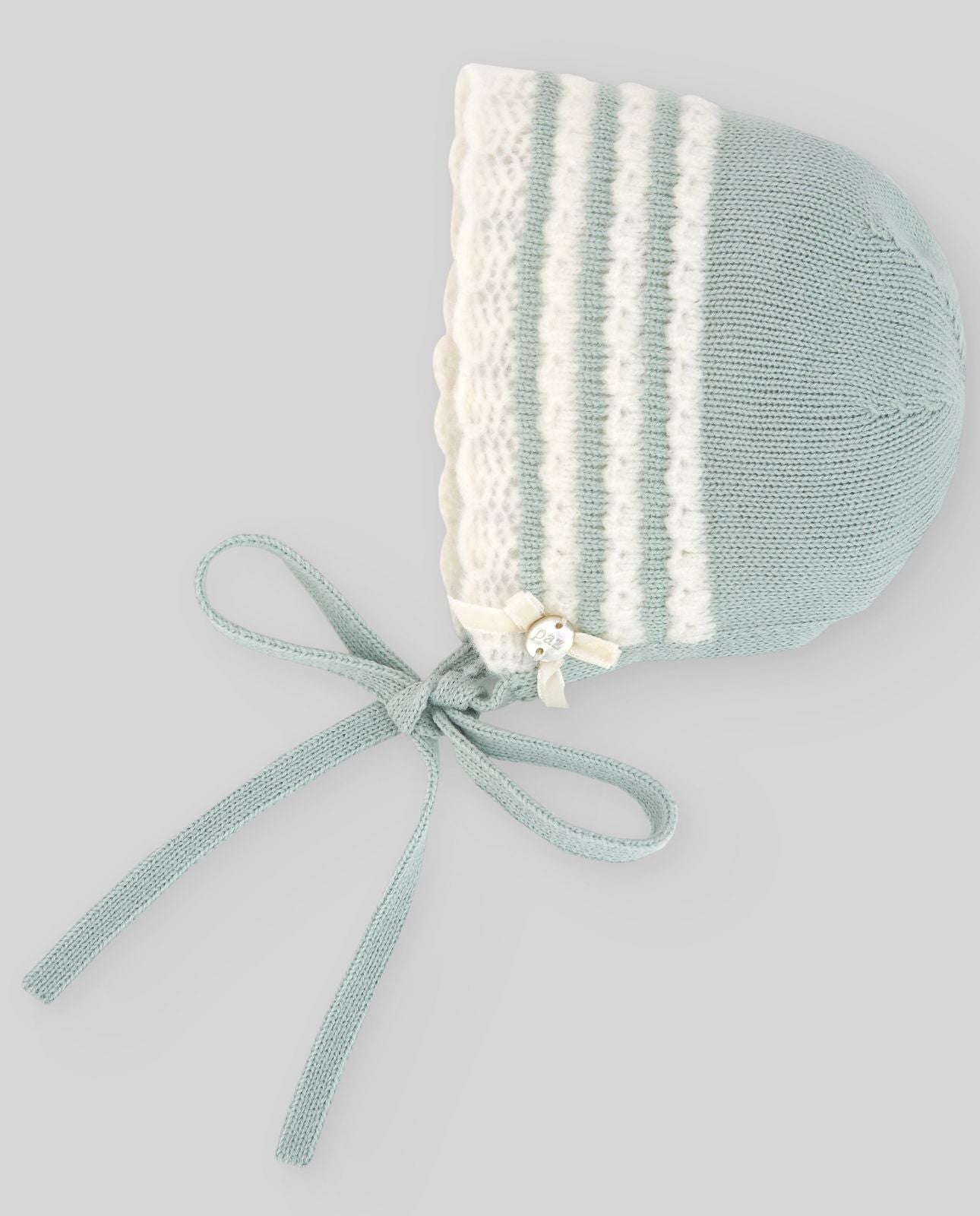 A knitted hat with white stripes and a bow;A blue and white striped hat with a tie around the neck