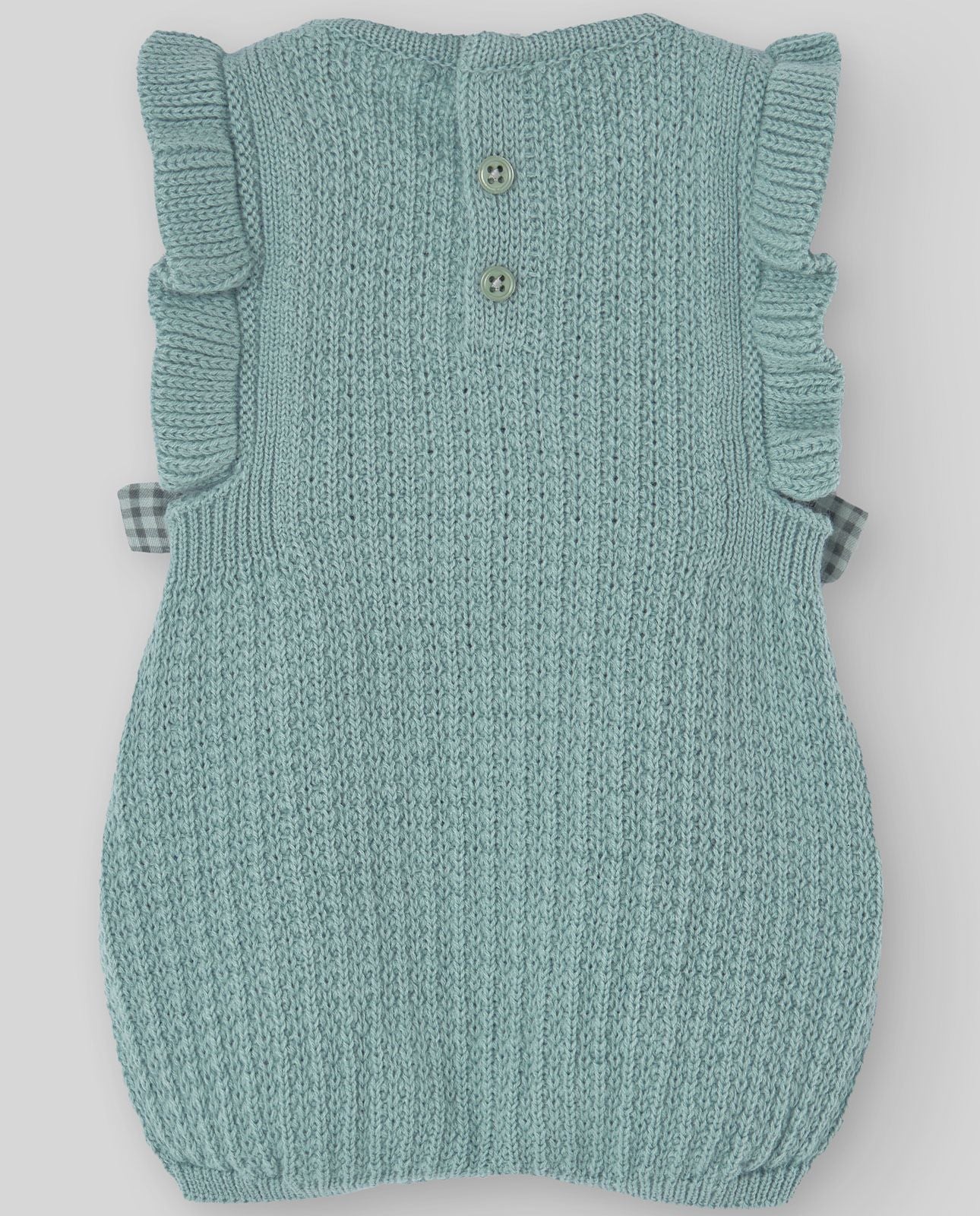A baby girl is wearing a green knitted dress with flowers on it.;A light blue sweater with ruffles on the sleeves