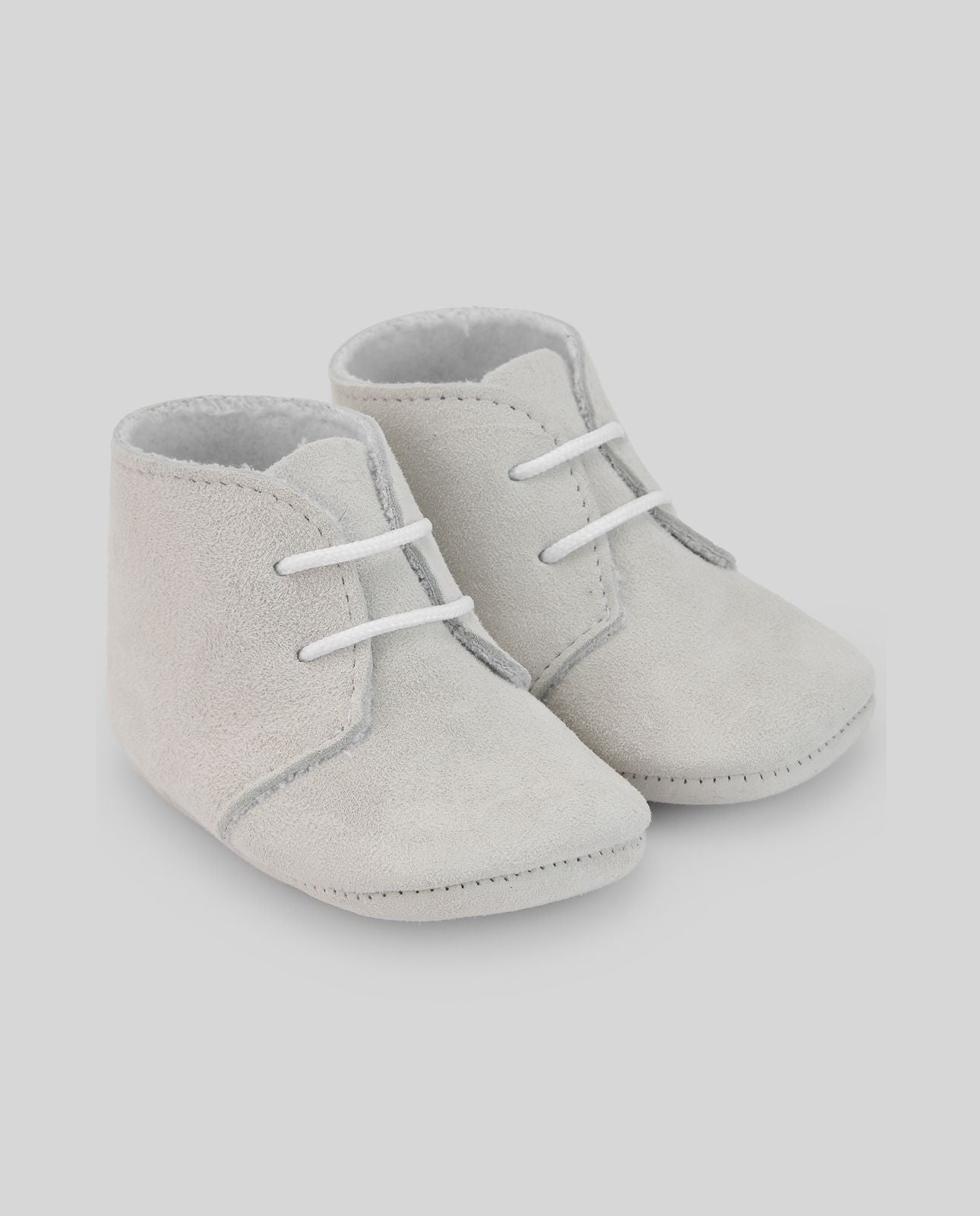 A pair of white baby shoes with white laces on a white background.;A pair of white baby shoes with white laces on a white background.;A pair of grey baby shoes with white laces on a white background.;A pair of grey baby shoes on a white background.;A pair of blue baby shoes with white laces