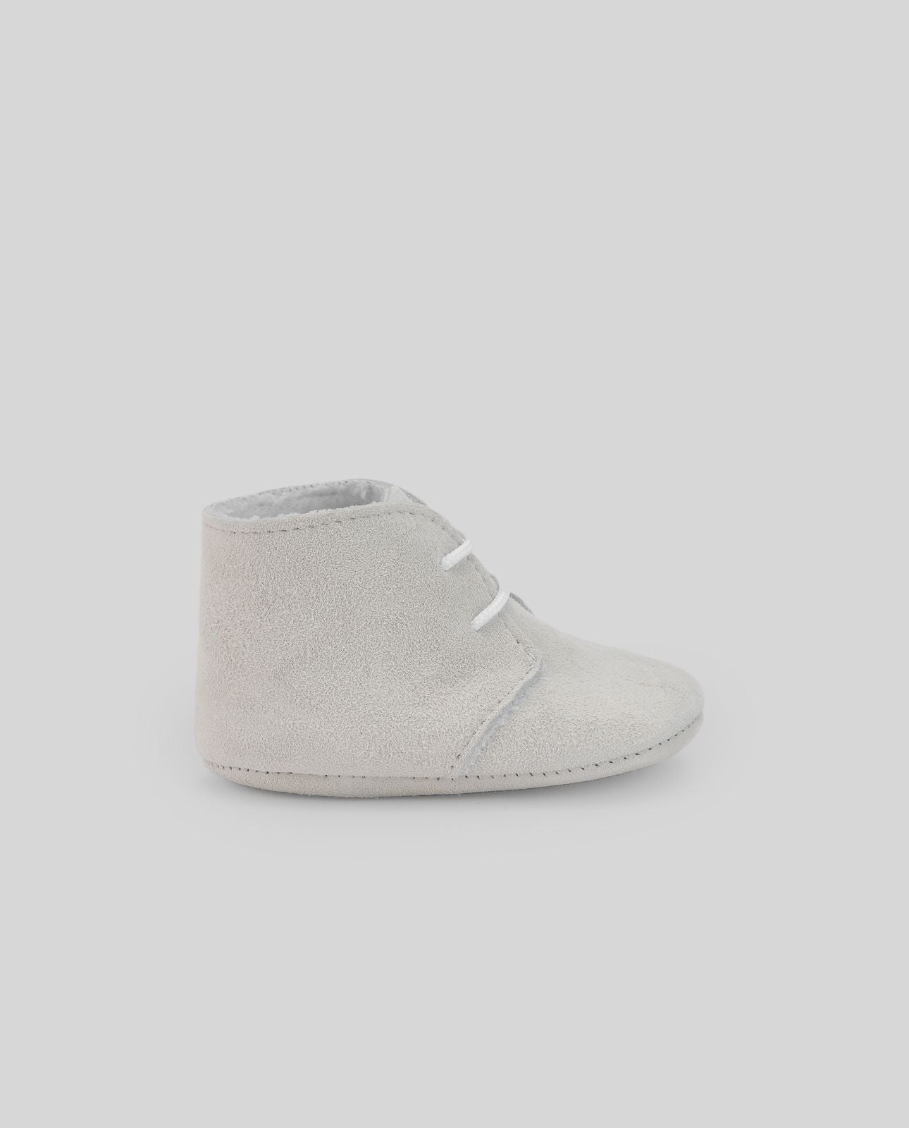 A pair of white baby shoes with white laces on a white background.;A pair of white baby shoes with white laces on a white background.;A pair of grey baby shoes with white laces on a white background.;A pair of grey baby shoes on a white background.;A pair of blue baby shoes with white laces