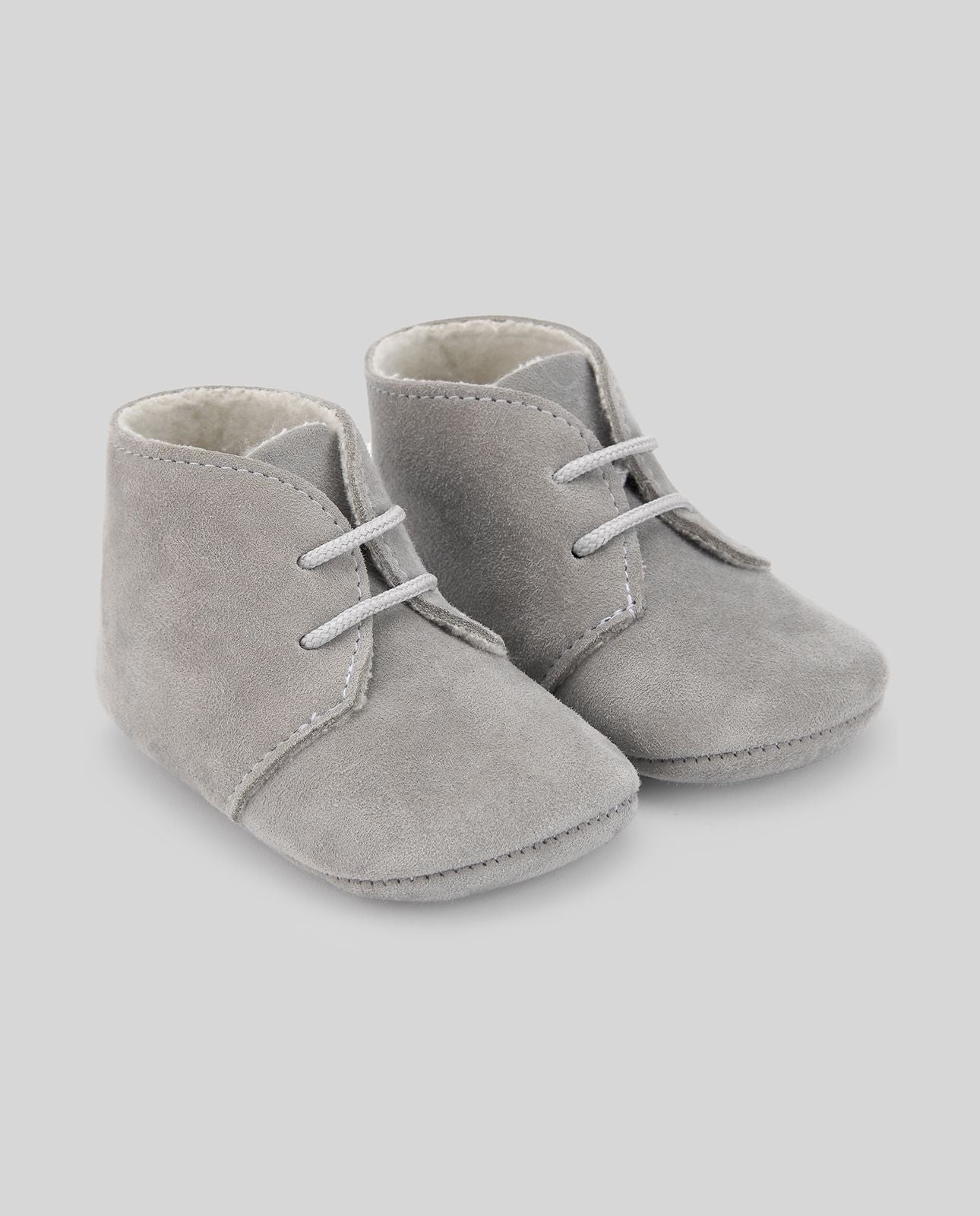 A pair of white baby shoes with white laces on a white background.;A pair of white baby shoes with white laces on a white background.;A pair of grey baby shoes with white laces on a white background.;A pair of grey baby shoes on a white background.;A pair of blue baby shoes with white laces