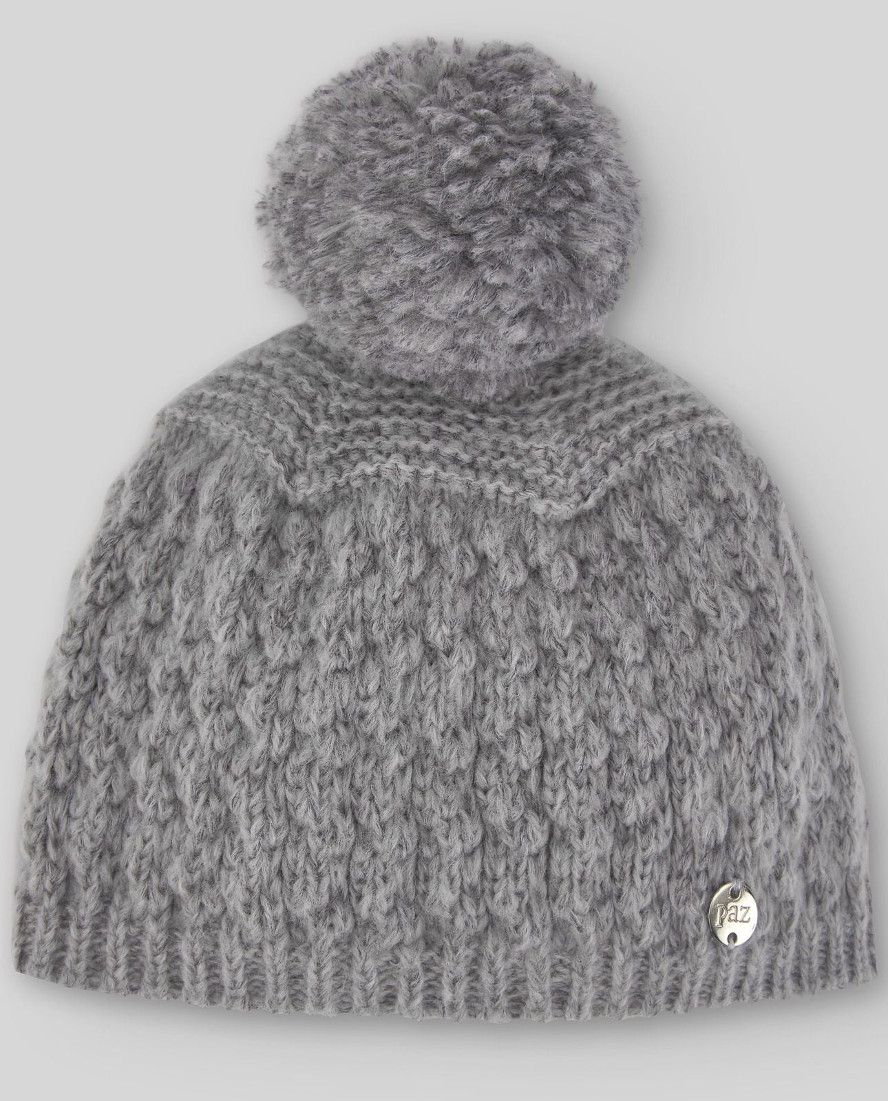 A grey knitted hat with a pom pom on top