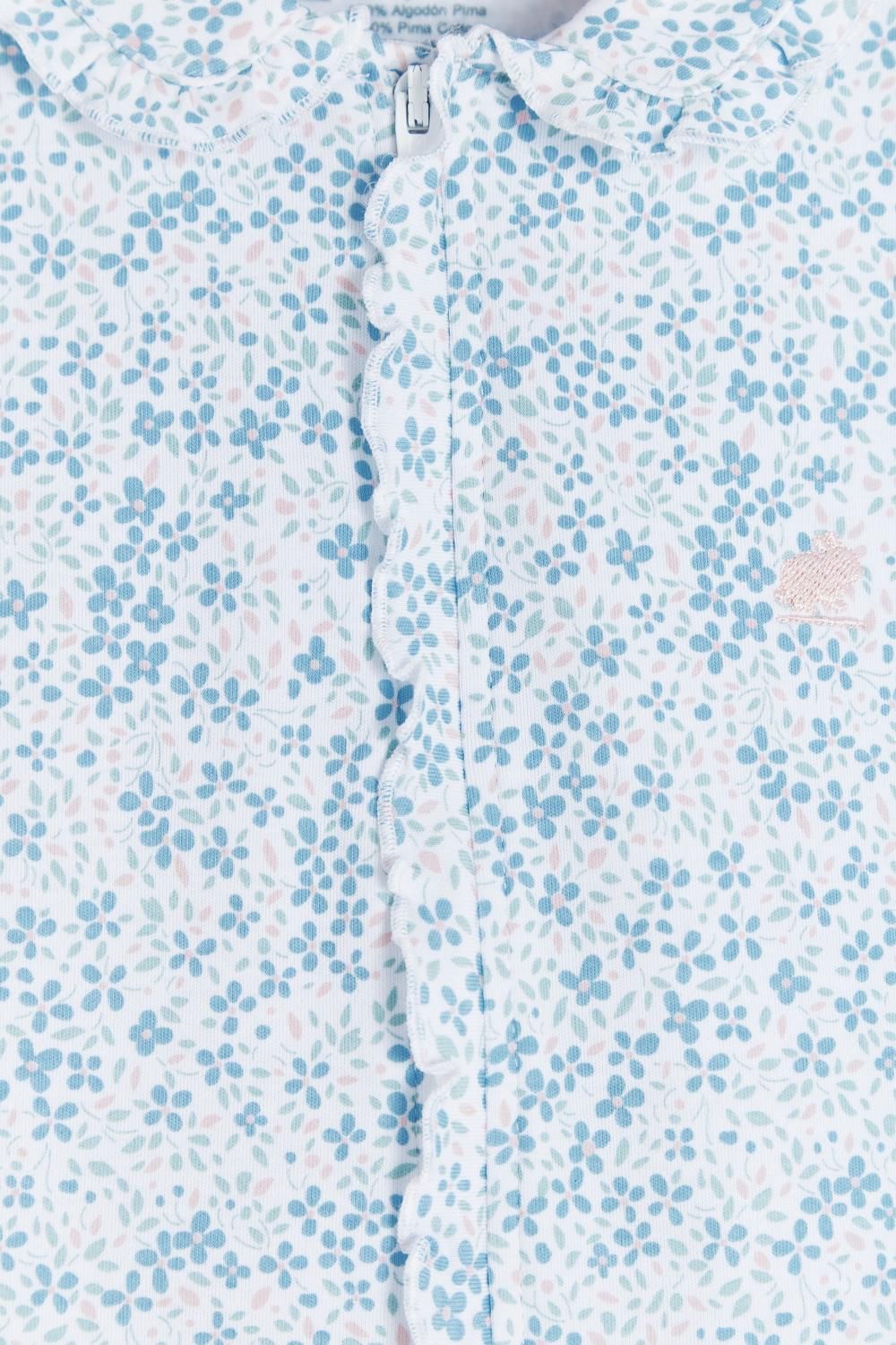 A baby onesie is hanging on a hanger on a white background.;The back of a baby onesie is hanging on a hanger.;A close up of a white shirt with blue flowers on it.;A baby onesie with blue flowers on it is hanging on a wooden hanger.