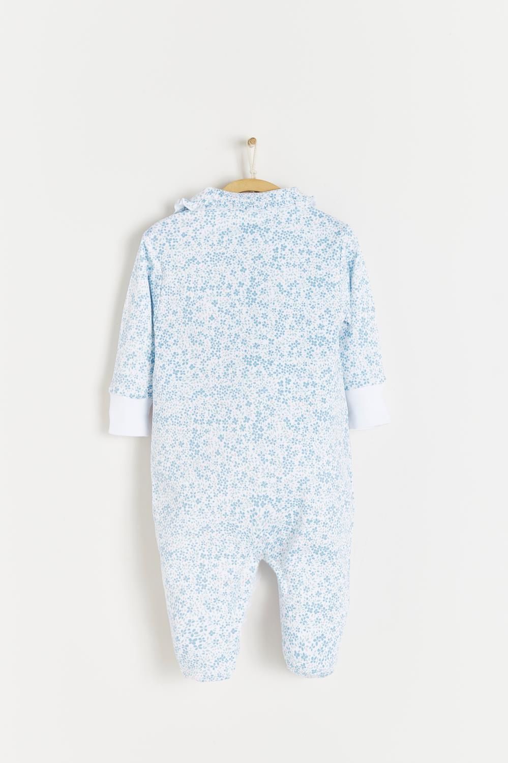A baby onesie is hanging on a hanger on a white background.;The back of a baby onesie is hanging on a hanger.;A close up of a white shirt with blue flowers on it.;A baby onesie with blue flowers on it is hanging on a wooden hanger.