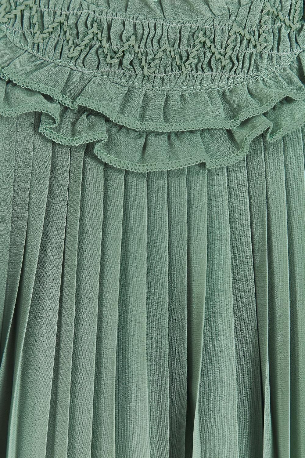 A green pleated dress is hanging on a wooden hanger.;A green dress with short sleeves is hanging on a hanger.;A close up of a green pleated skirt with ruffles on the bottom.