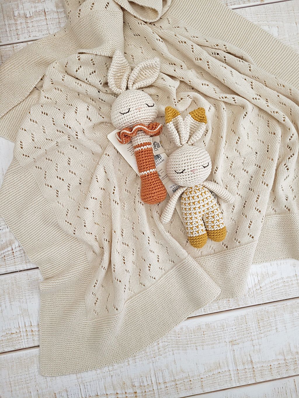 A close up of a knitted blanket on a white background.