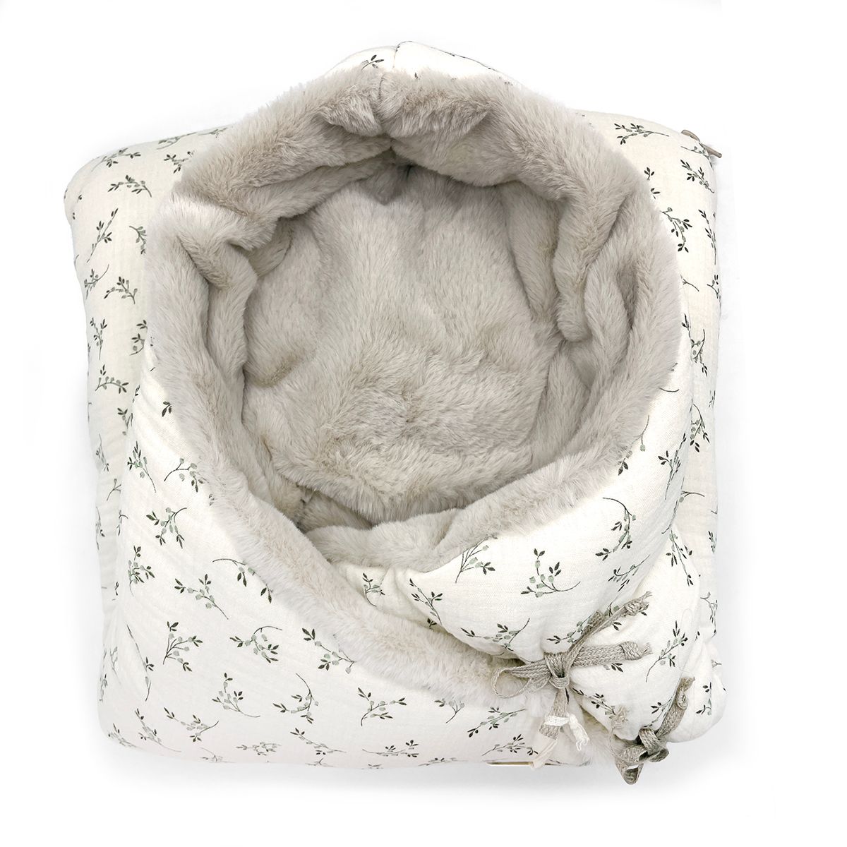 A white blanket with polka dots on it;A baby sleeping bag with a floral pattern on it;A white blanket with a hood and flowers on it;A close up of a blanket with flowers on it;A white blanket with a hood and flowers on it;A white and grey blanket with a floral pattern on it