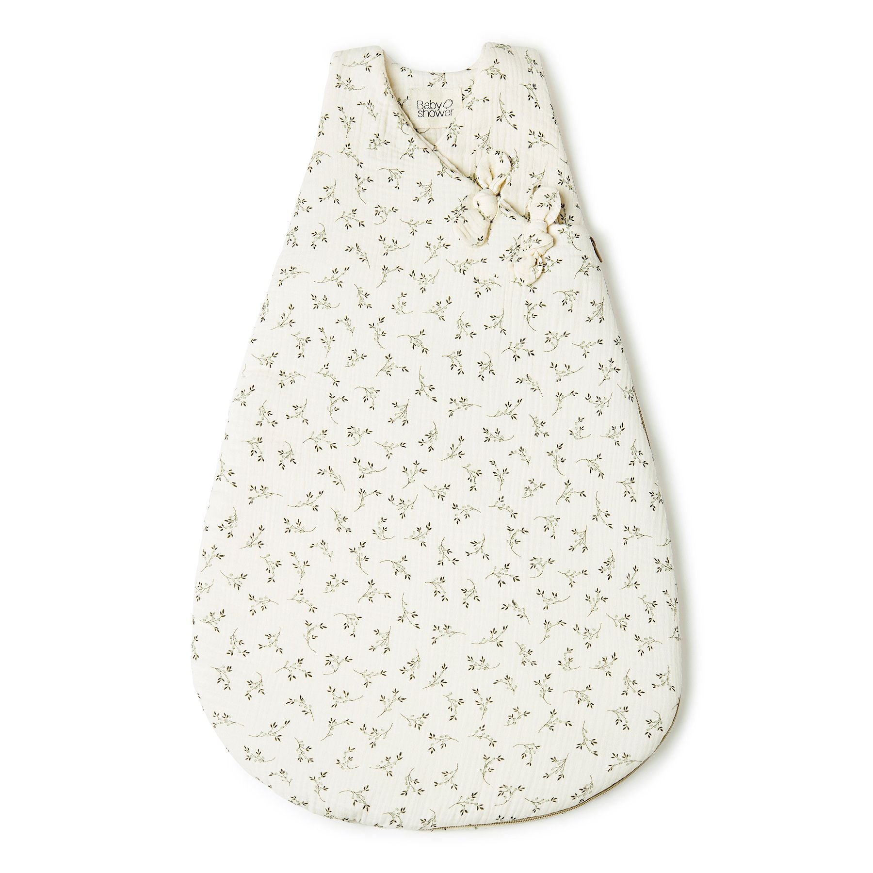 A white sleeping bag with black dots on it is on a white background.;A baby sleeping bag with a floral print on a white background.;A white sleeping bag with black dots on it is on a white background.;A baby sleeping bag with a floral pattern on it.;A white baby sleeping bag with polka dots on it is on a white background.;A baby sleeping bag with a floral pattern on it is on a white background.