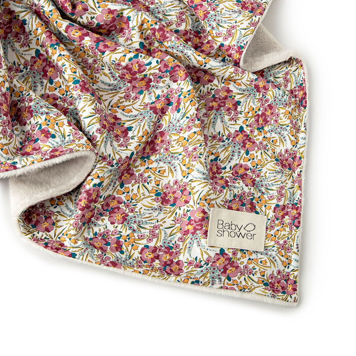 A close up of a floral blanket on a white background.