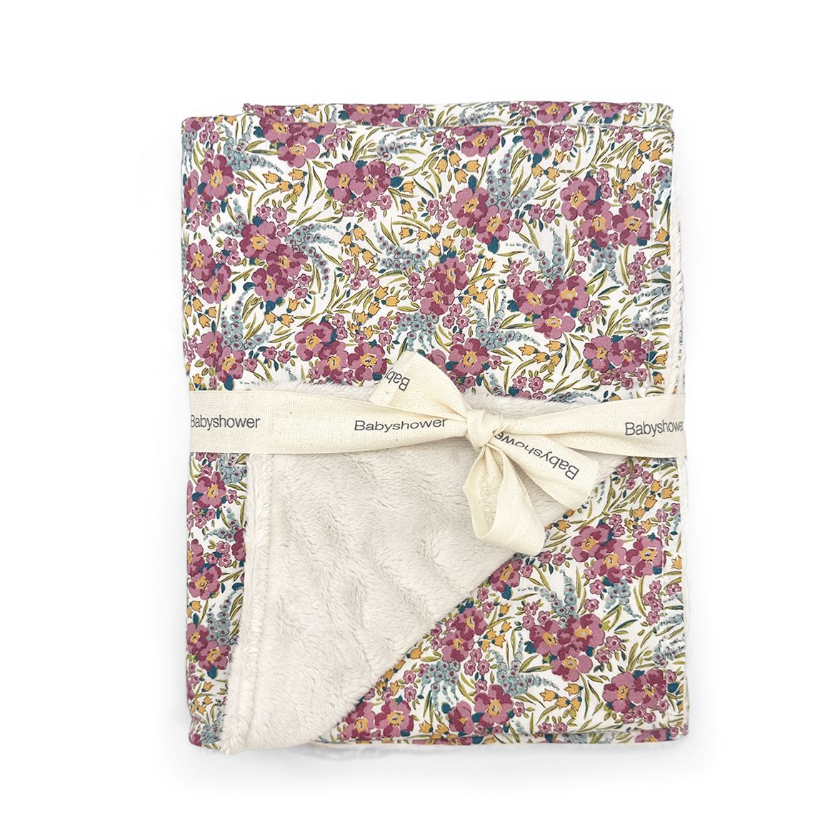 A blanket with a floral pattern and a white ribbon tied around it.;A blanket with a floral pattern and a white ribbon tied around it.;A blanket with a floral pattern and a white ribbon tied around it.;A blanket with a floral pattern and a bow on it.;A blanket with a bow on it is sitting on a table.
