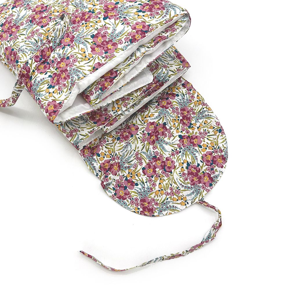 A close up of a floral oven mitt on a white background.