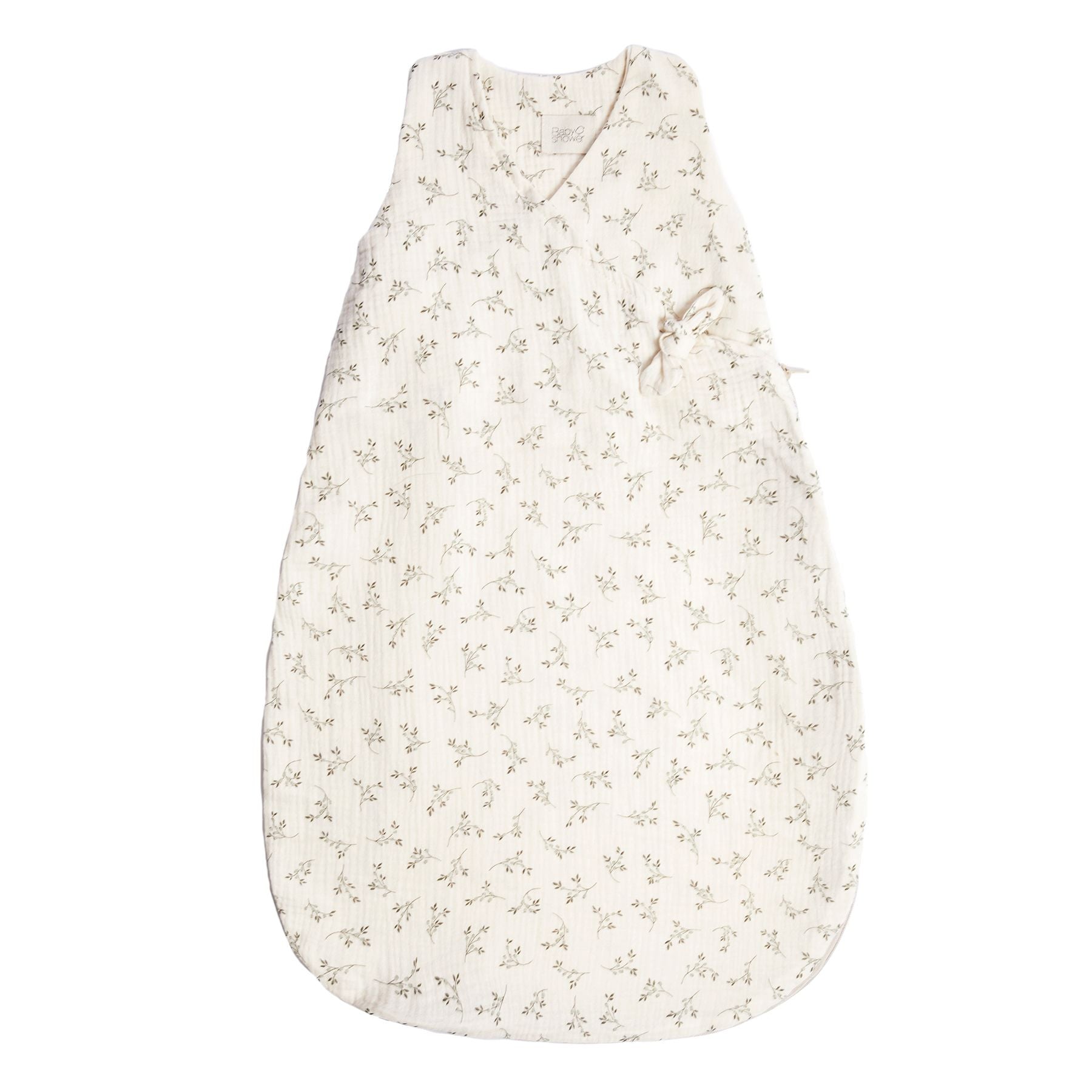 A white baby sleeping bag with a floral pattern on it.