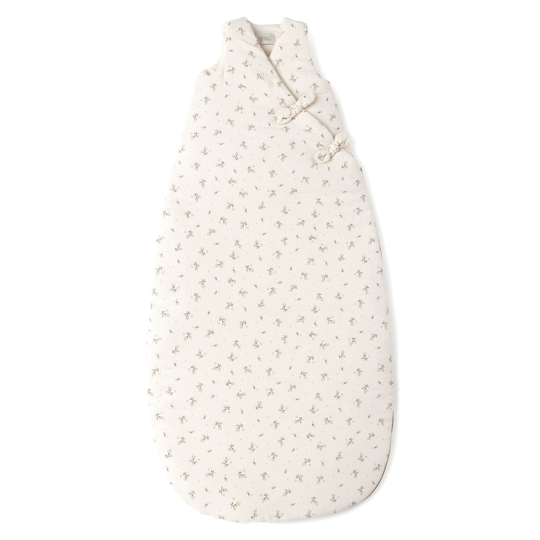 A white baby sleeping bag with black dots on it on a white background.