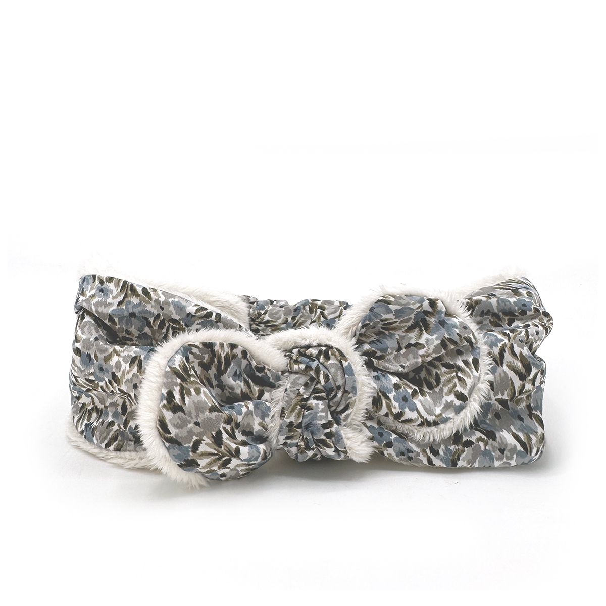A headband with a floral pattern and a bow on a white background.