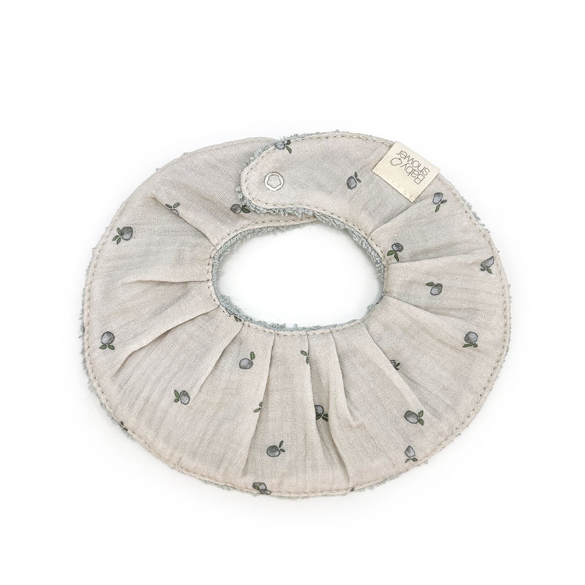 A gray bib with flowers on it is on a white background.