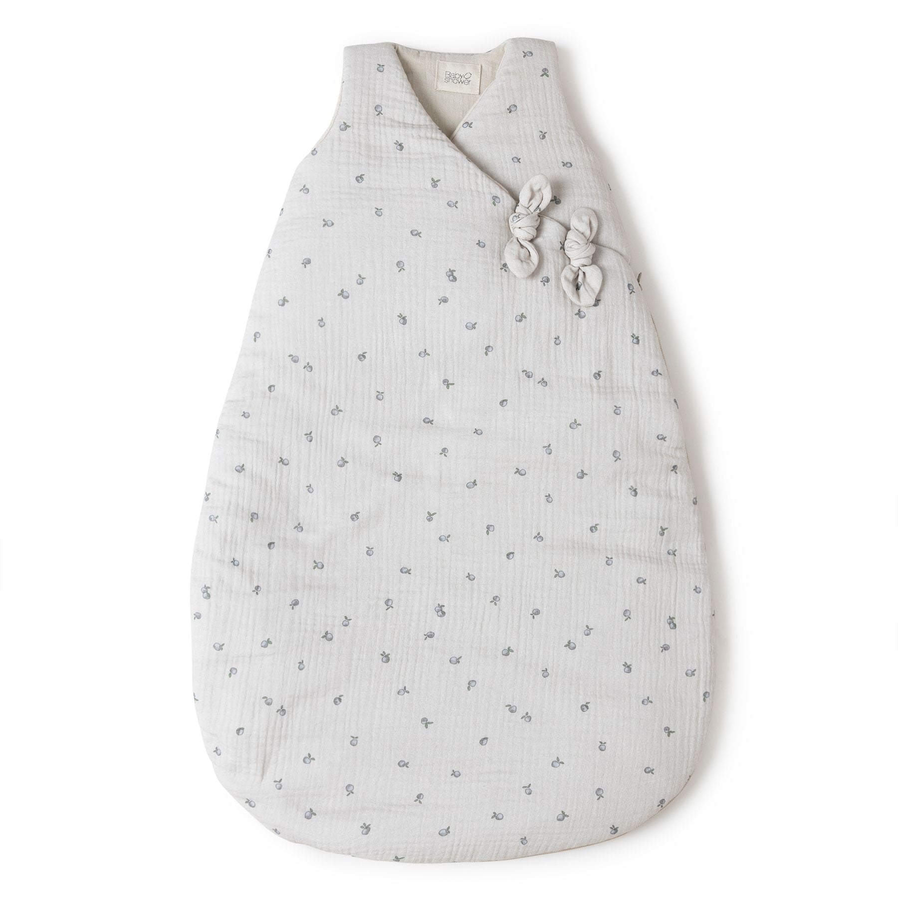 A white sleeping bag with black dots on it is on a white background.;A baby sleeping bag with a floral print on a white background.;A white sleeping bag with black dots on it is on a white background.;A baby sleeping bag with a floral pattern on it.;A white baby sleeping bag with polka dots on it is on a white background.;A baby sleeping bag with a floral pattern on it is on a white background.
