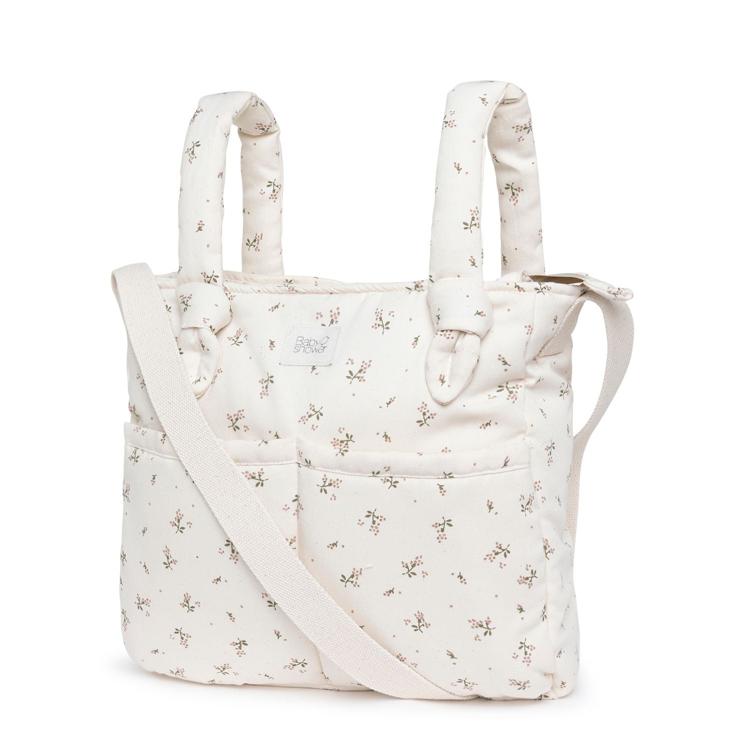 A white tote bag with a floral pattern on it;A light blue diaper bag with a beige strap;A white tote bag with a floral pattern on it;A white tote bag with flowers on it and a white strap