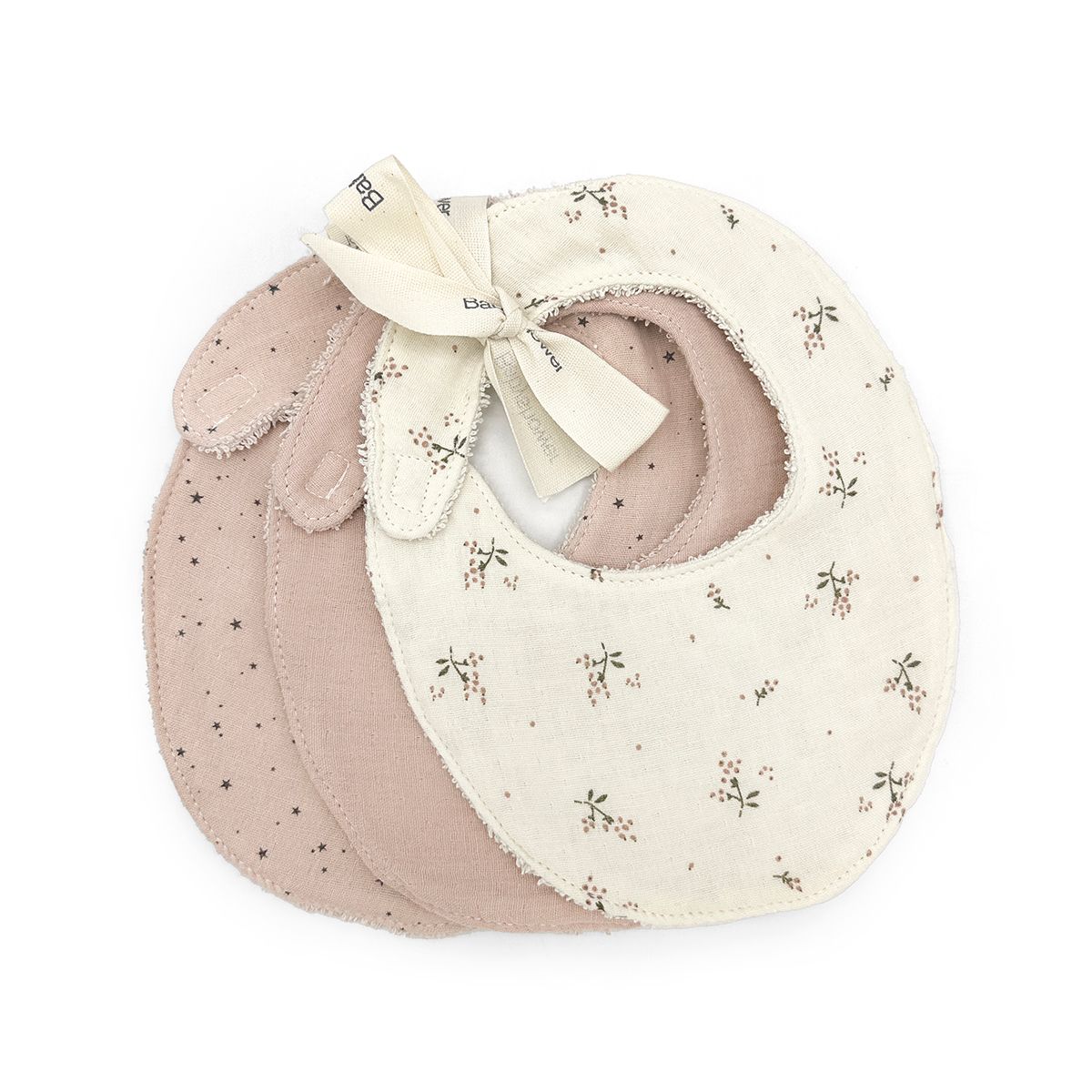 Three bibs are stacked on top of each other on a white surface.
