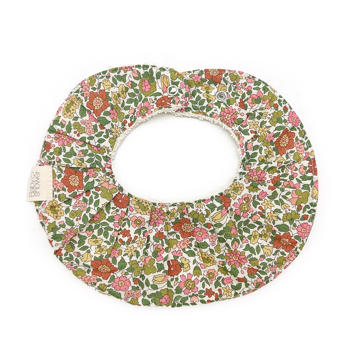 A bib with a floral pattern on it is on a white background.