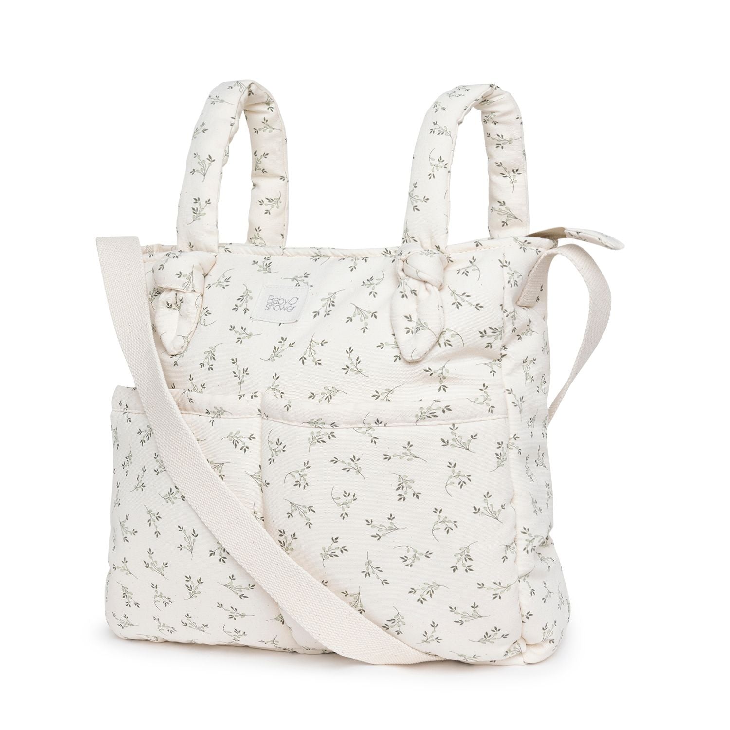 A white tote bag with a floral pattern on it;A light blue diaper bag with a beige strap;A white tote bag with a floral pattern on it;A white tote bag with flowers on it and a white strap