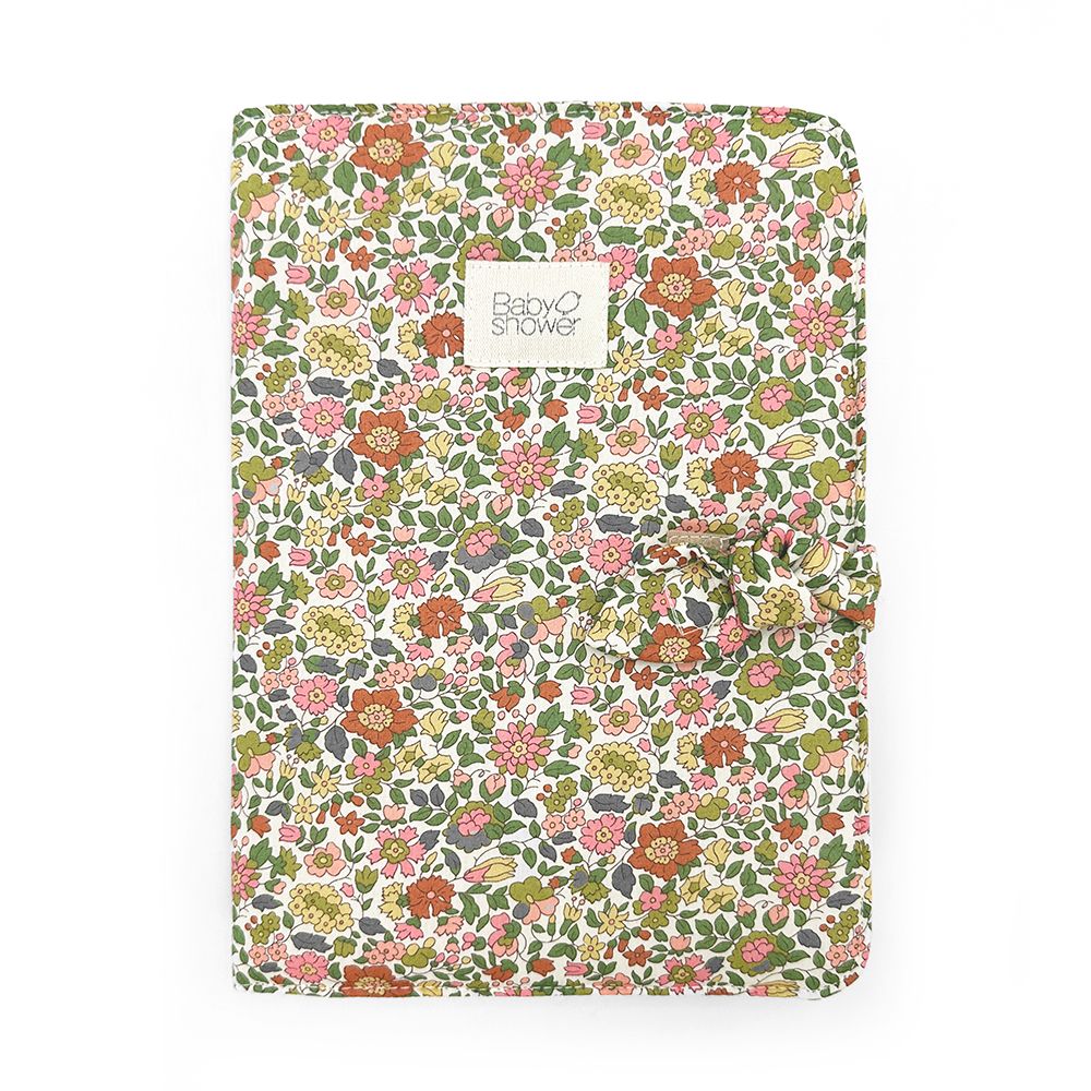 A white blanket with blue and yellow flowers on it.;A blanket with a floral pattern on it is on a white background.;A gray blanket with a bow on it on a white background.;A notebook with a floral pattern on it is on a white background.;A bag with a floral pattern on it is on a white background.;A pink waffle blanket with a white label on it is tied with a bow.