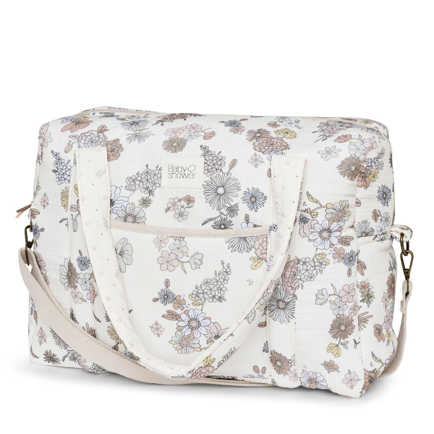 A white diaper bag with a floral pattern on it