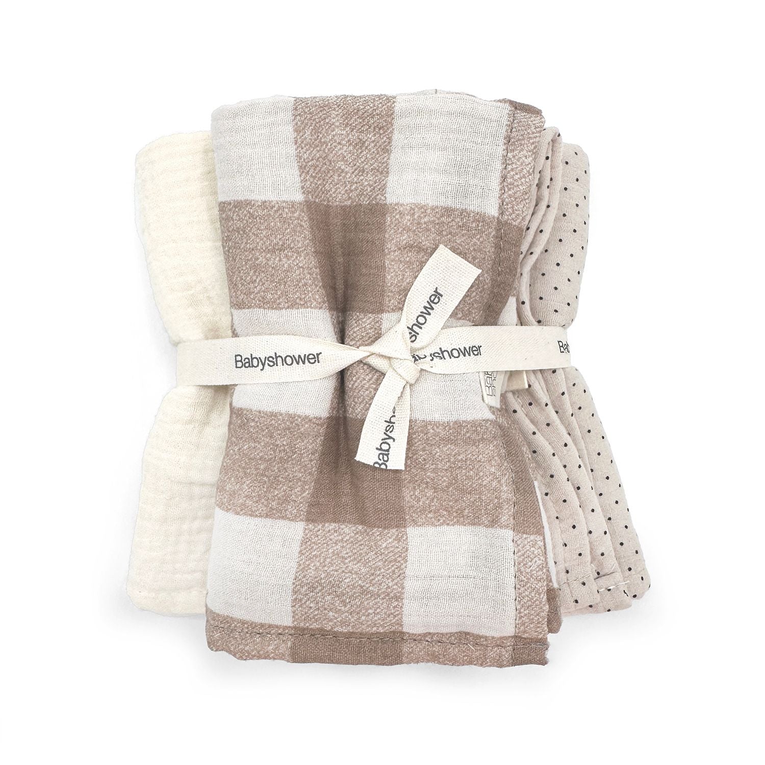 A stack of towels tied together with a ribbon on a white background.