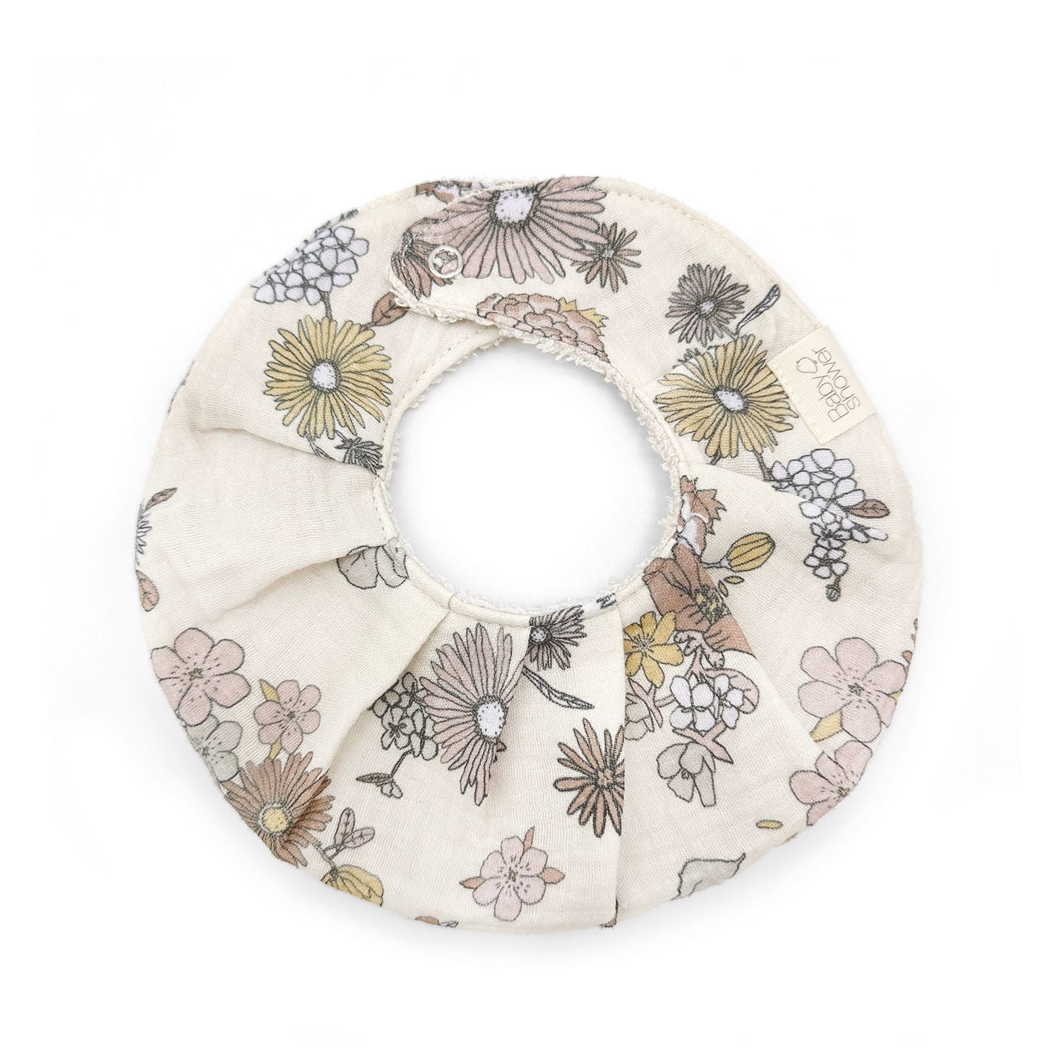 A bib with a floral pattern on it is on a white background.