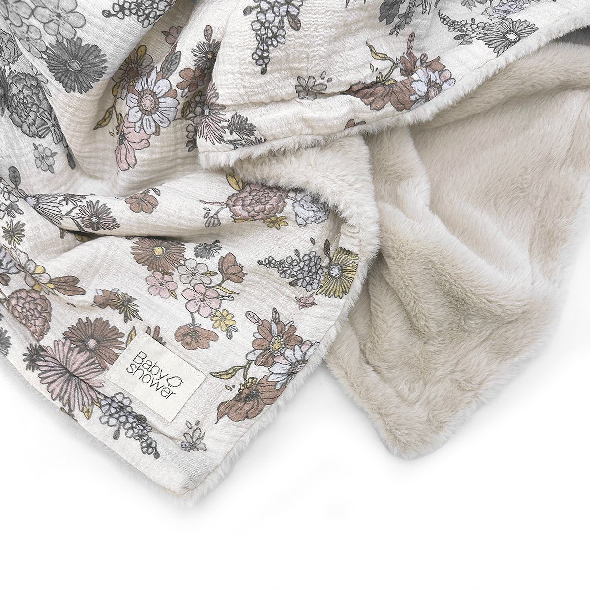 A close up of a blanket with flowers on it on a white background.