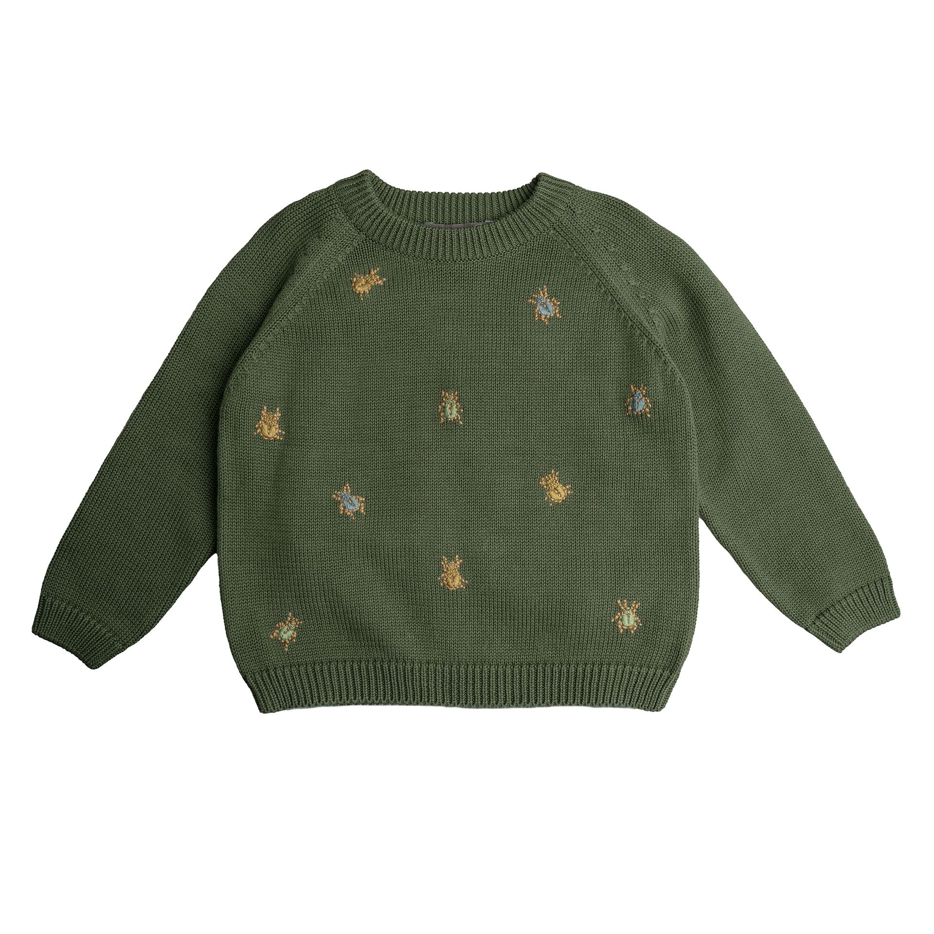 A young boy wearing a green sweater and blue pants is standing in front of a brick wall.;A green sweater with gold bees embroidered on it;A green sweater with long sleeves on a white background;A close up of a green sweater with bees embroidered on it.