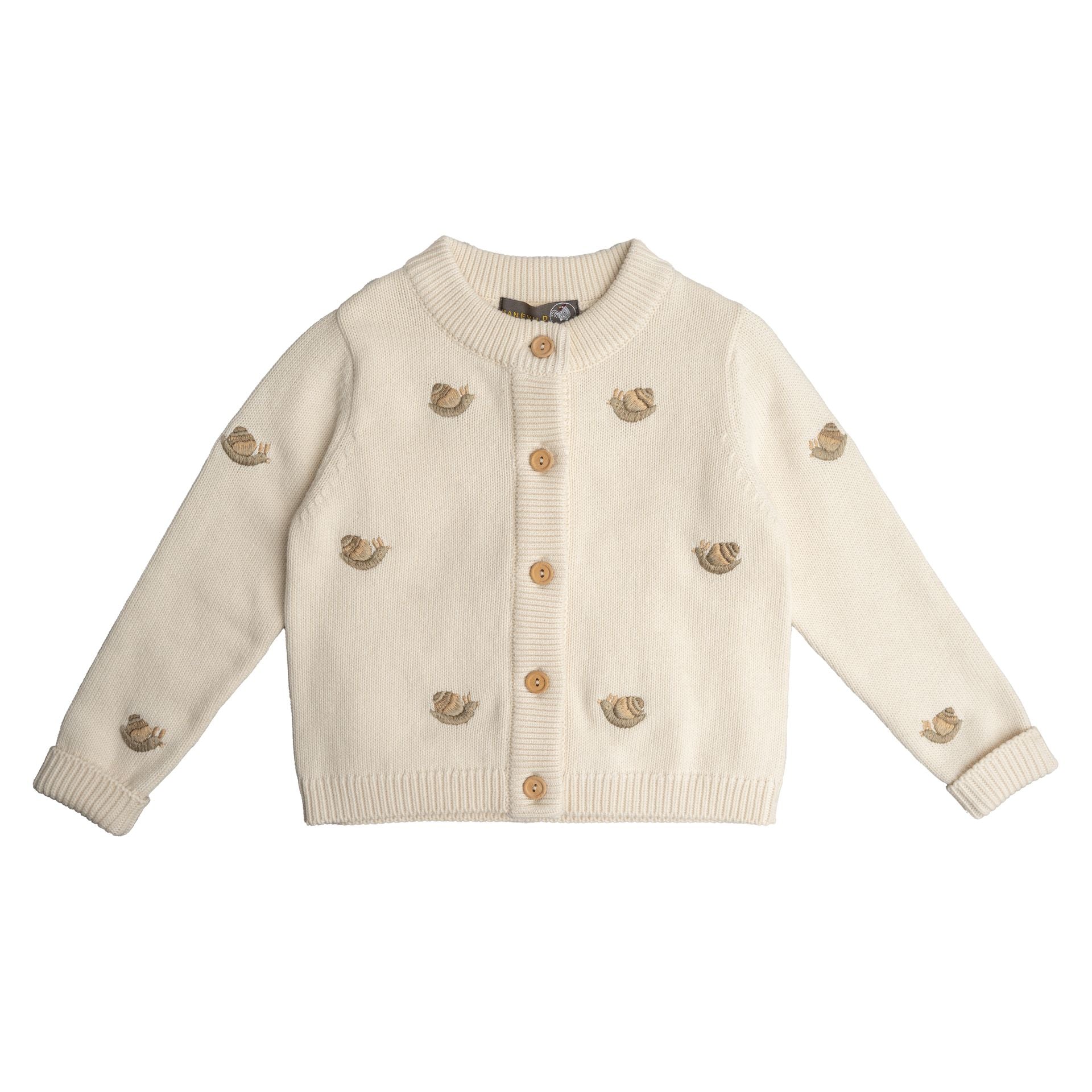 A young boy is sitting on a chair wearing a white sweater.;A white cardigan with squirrels embroidered on it;The back of a white sweater with long sleeves on a white background.;A close up of a sweater with a sheep embroidered on it.