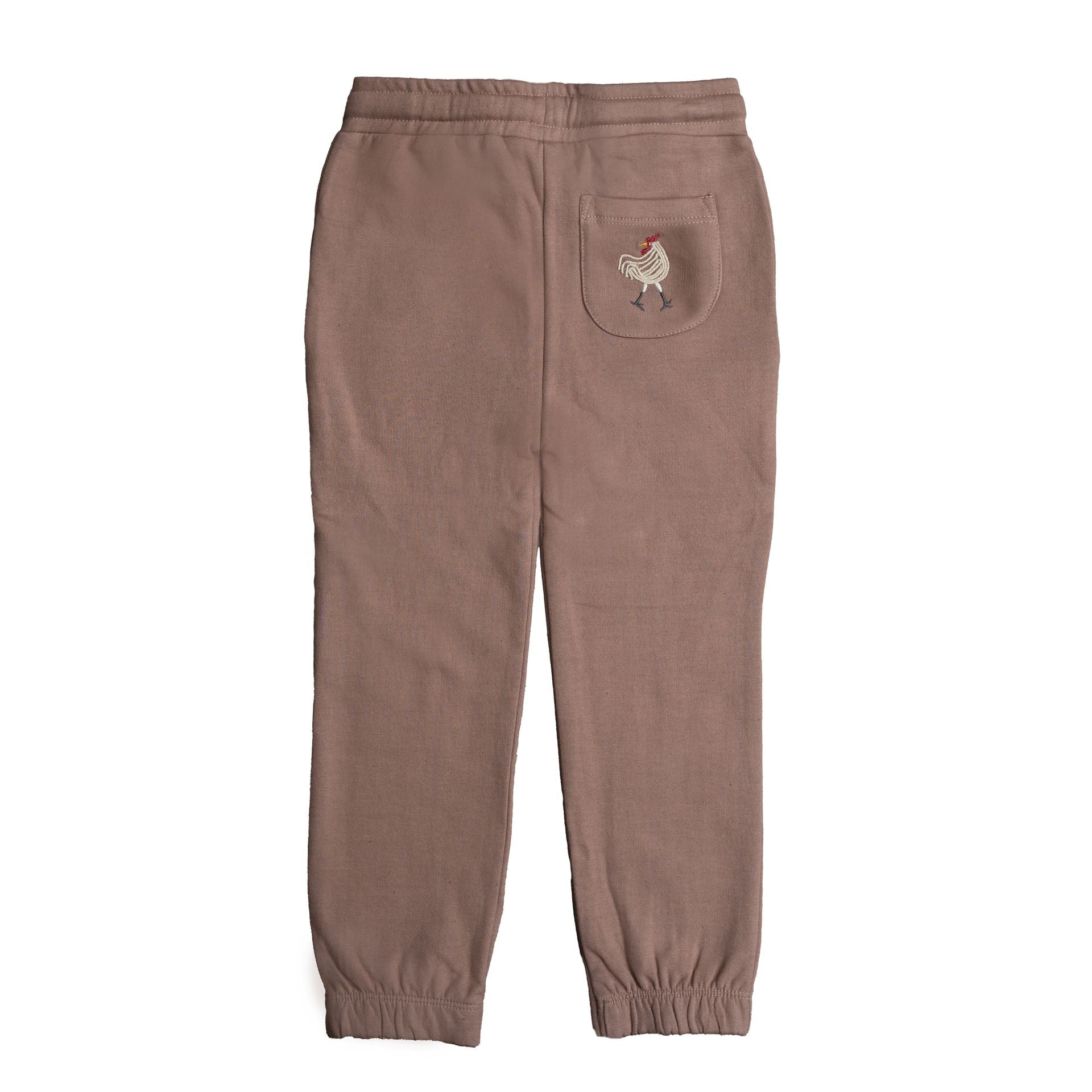 A little boy wearing a brown hat and a brown sweater is standing with his hands in his pockets.;A pair of brown sweatpants with a sheep embroidered on the back pocket;A pair of brown sweatpants on a white background