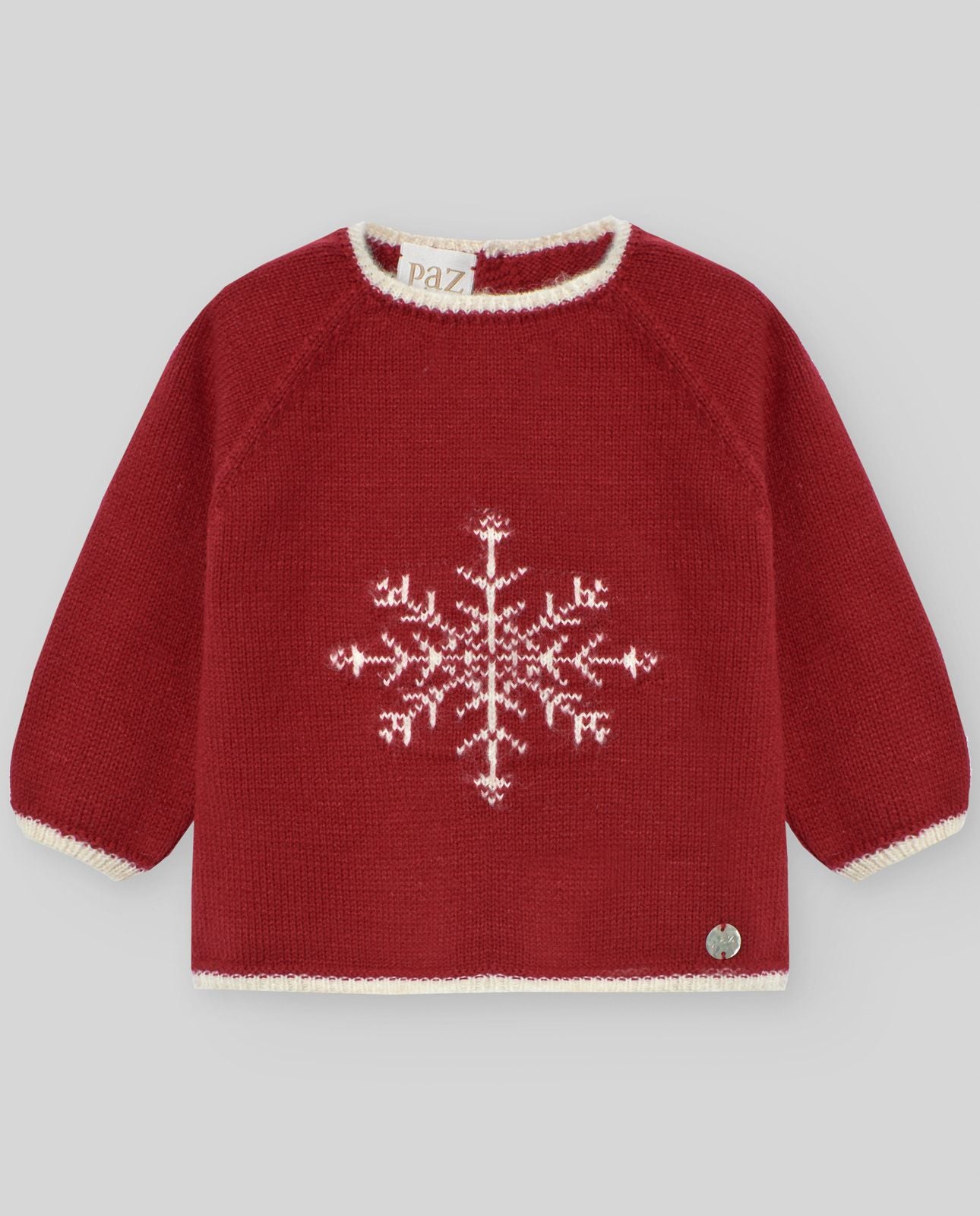 A baby is wearing a red sweater and pants with a snowflake on it.;A red sweater with a white snowflake on it;The back of a red sweater with white trim and buttons.;A pair of red knitted baby pants with feet