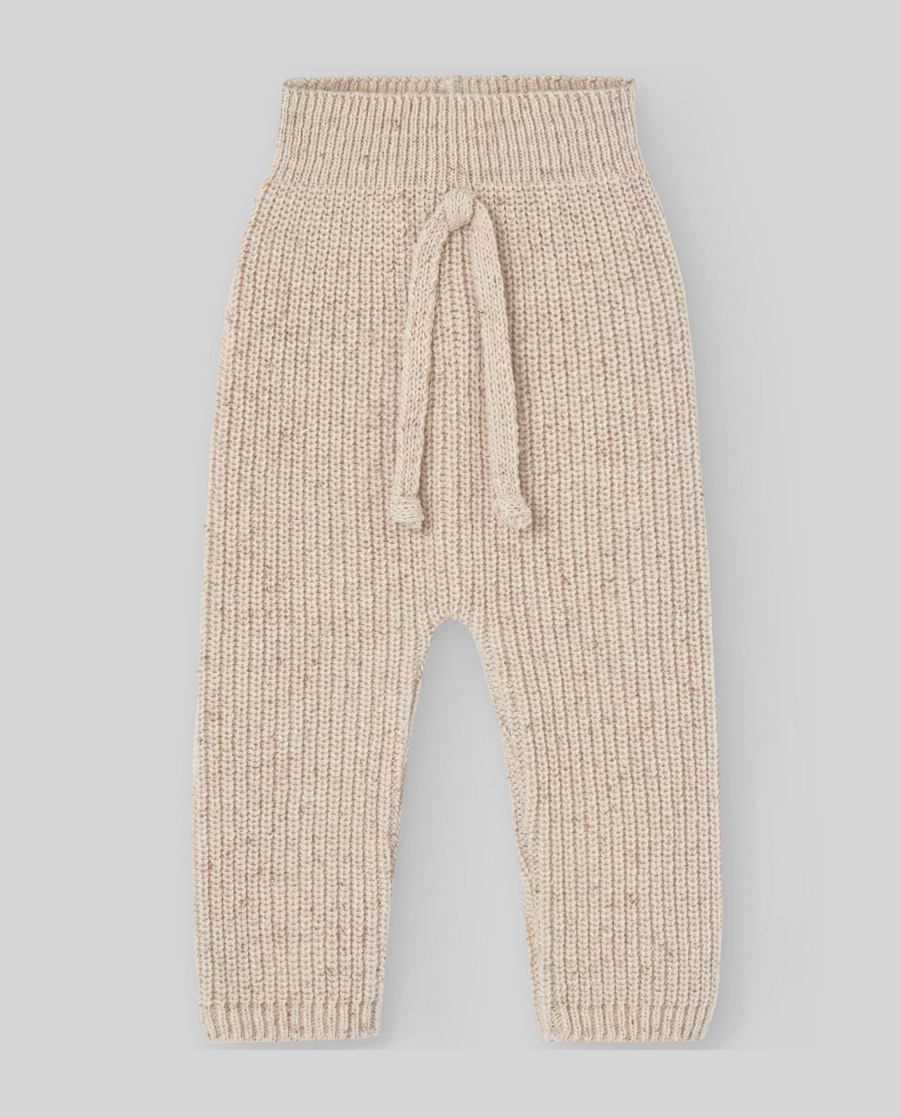 A baby is wearing a beige sweater with buttons on the sleeves.;A close up of a beige sweater with long sleeves on a white background.;A pair of beige pants with a pattern on them on a white background.;A pair of beige pants with a pattern on them