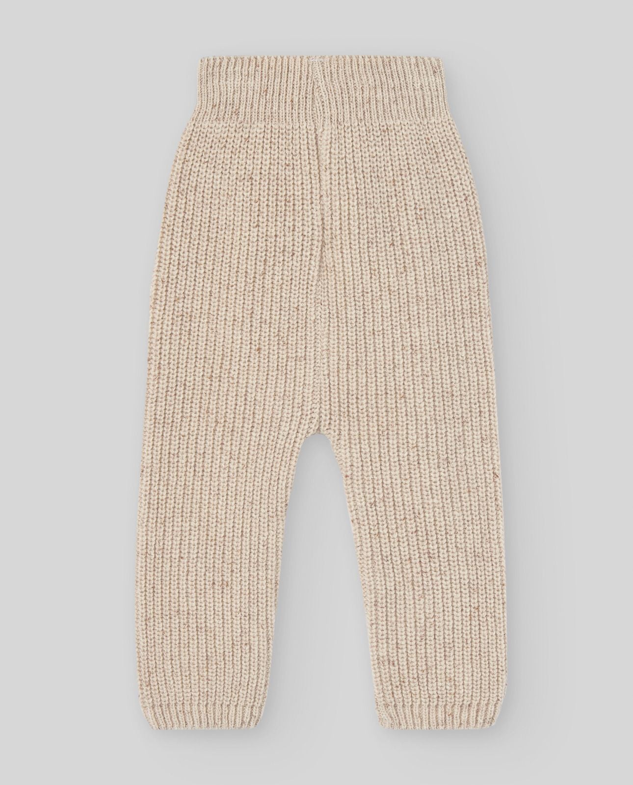 A baby is wearing a beige sweater with buttons on the sleeves.;A close up of a beige sweater with long sleeves on a white background.;A pair of beige pants with a pattern on them on a white background.;A pair of beige pants with a pattern on them