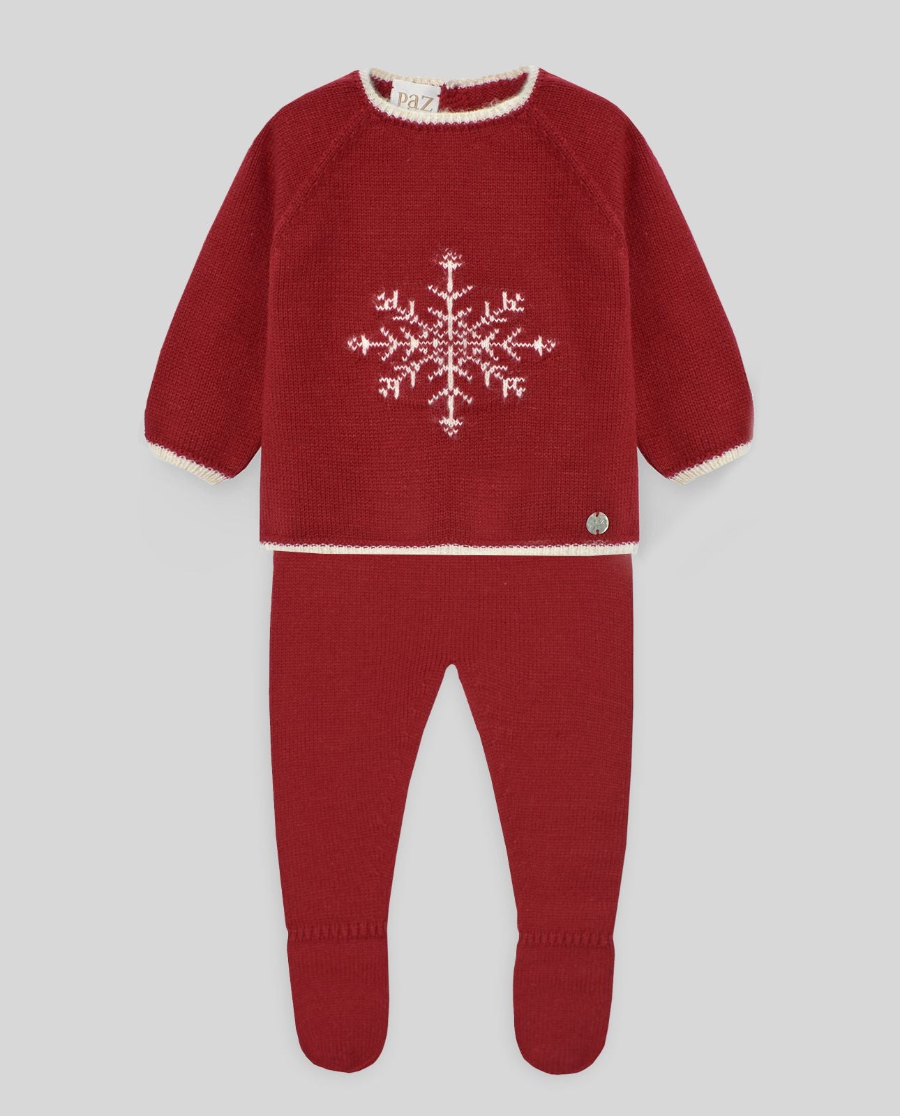 A baby is wearing a red sweater and pants with a snowflake on it.;A red sweater with a white snowflake on it;The back of a red sweater with white trim and buttons.;A pair of red knitted baby pants with feet