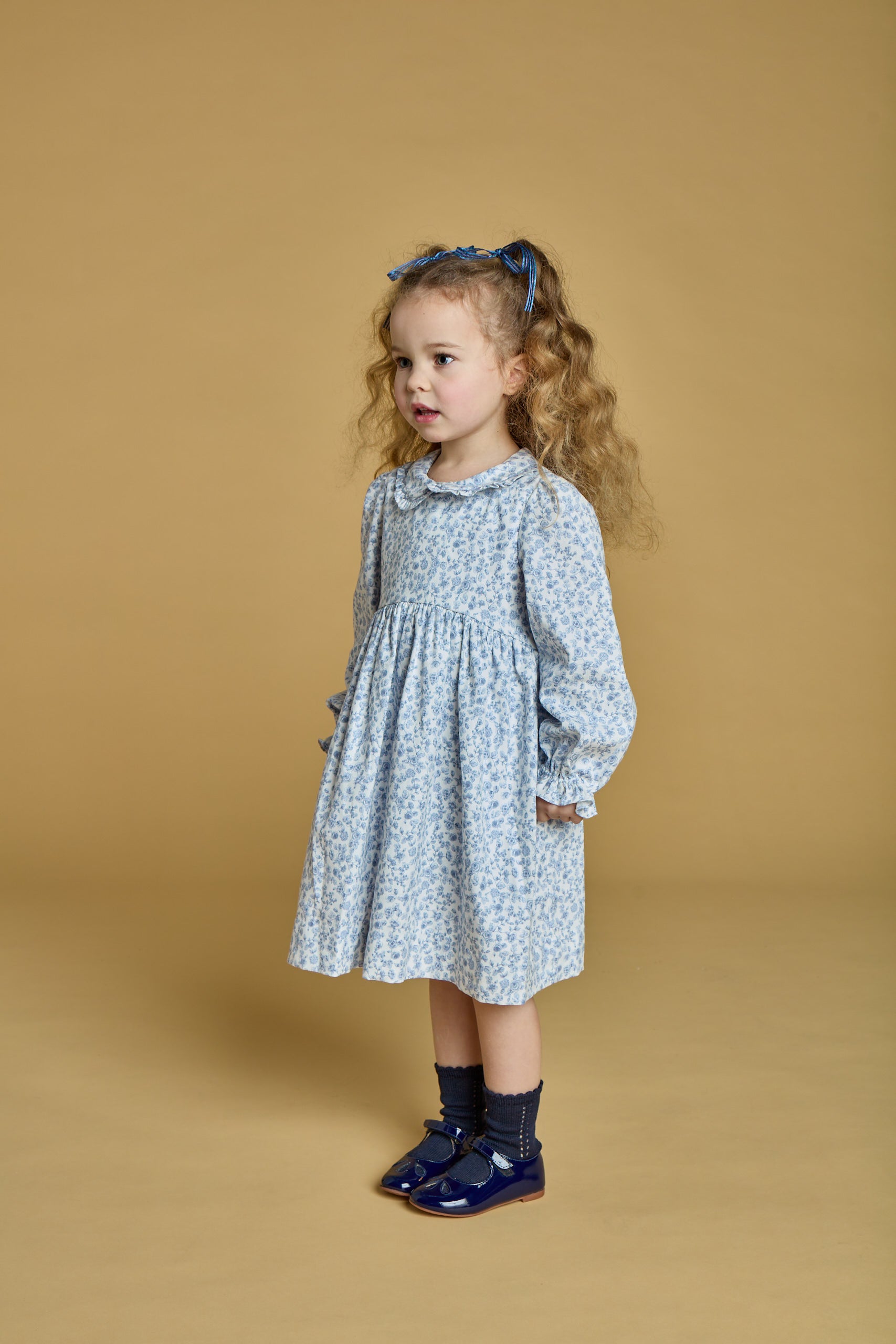Anthea, smocked girl romper, in Blue garden print