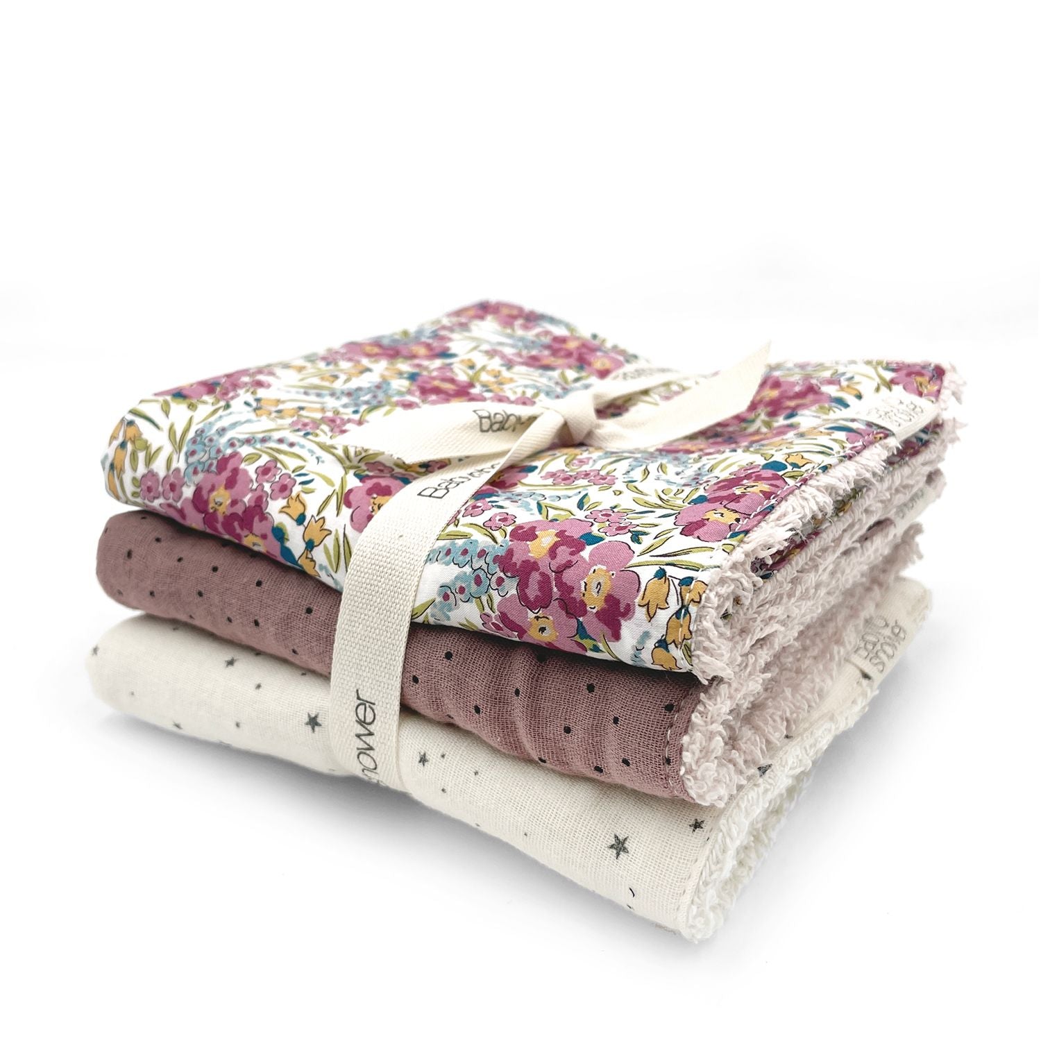 Three towels are stacked on top of each other on a white background.