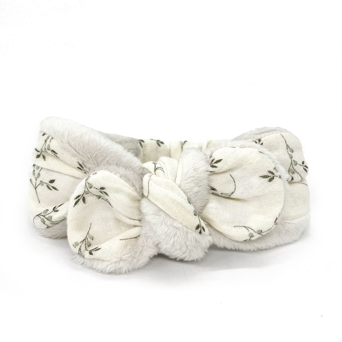 A white headband with a bow on it on a white background.
