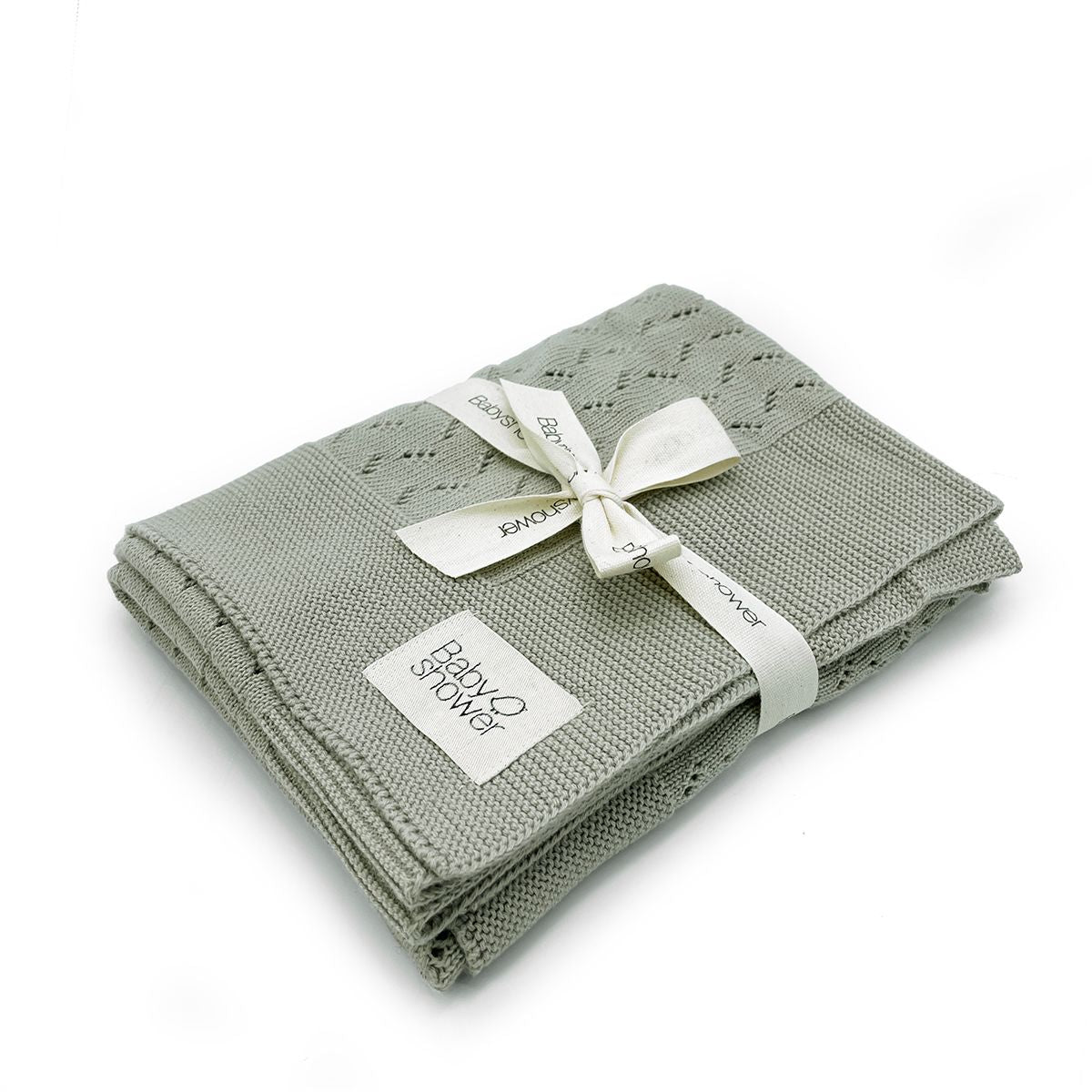 A blanket is wrapped in a white ribbon and tied with a bow.