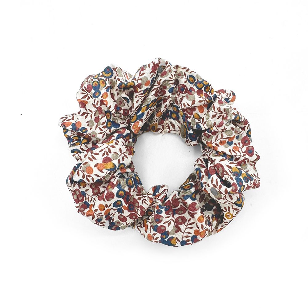 A scrunchie with a floral pattern on a white background.