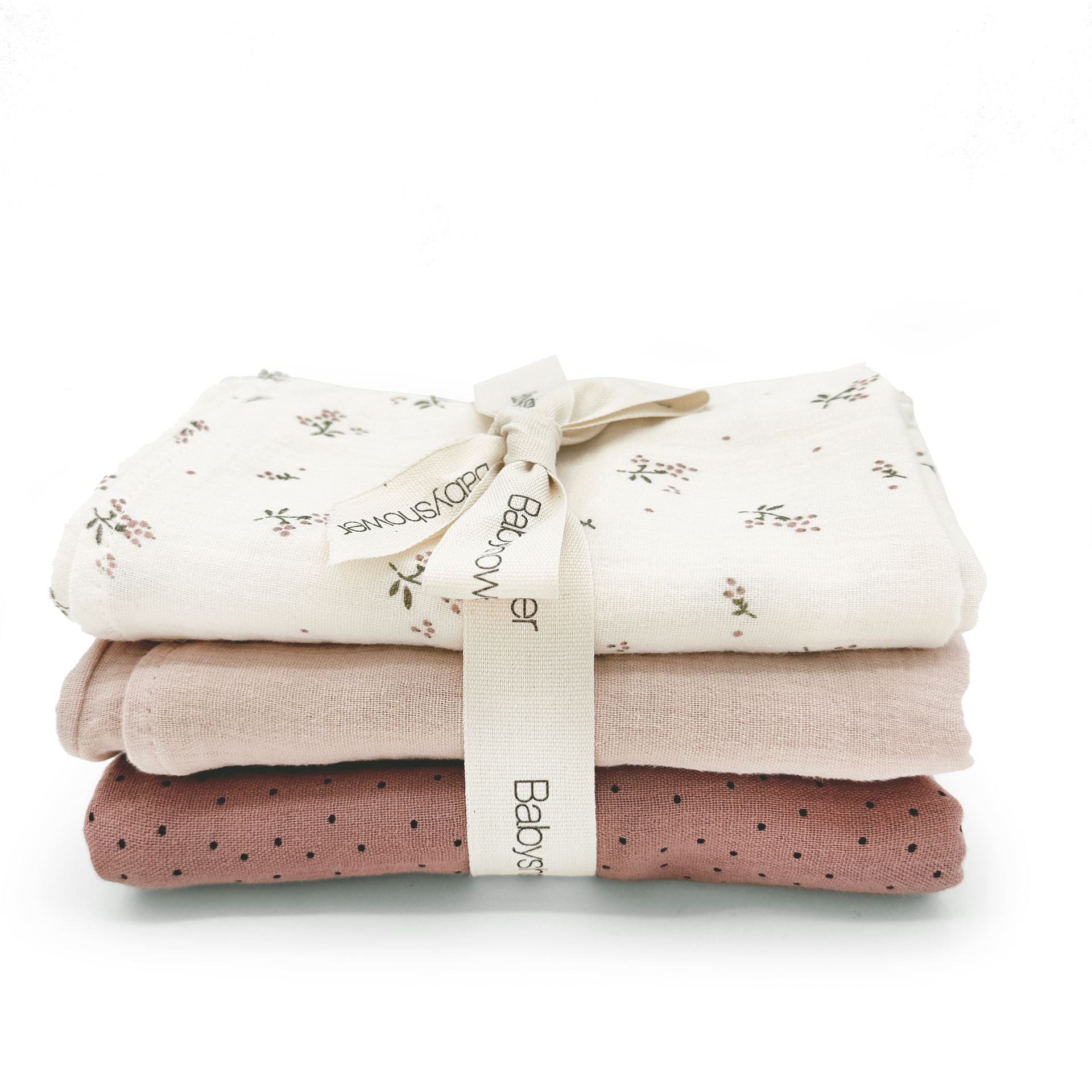 Three towels are stacked on top of each other on a white background.